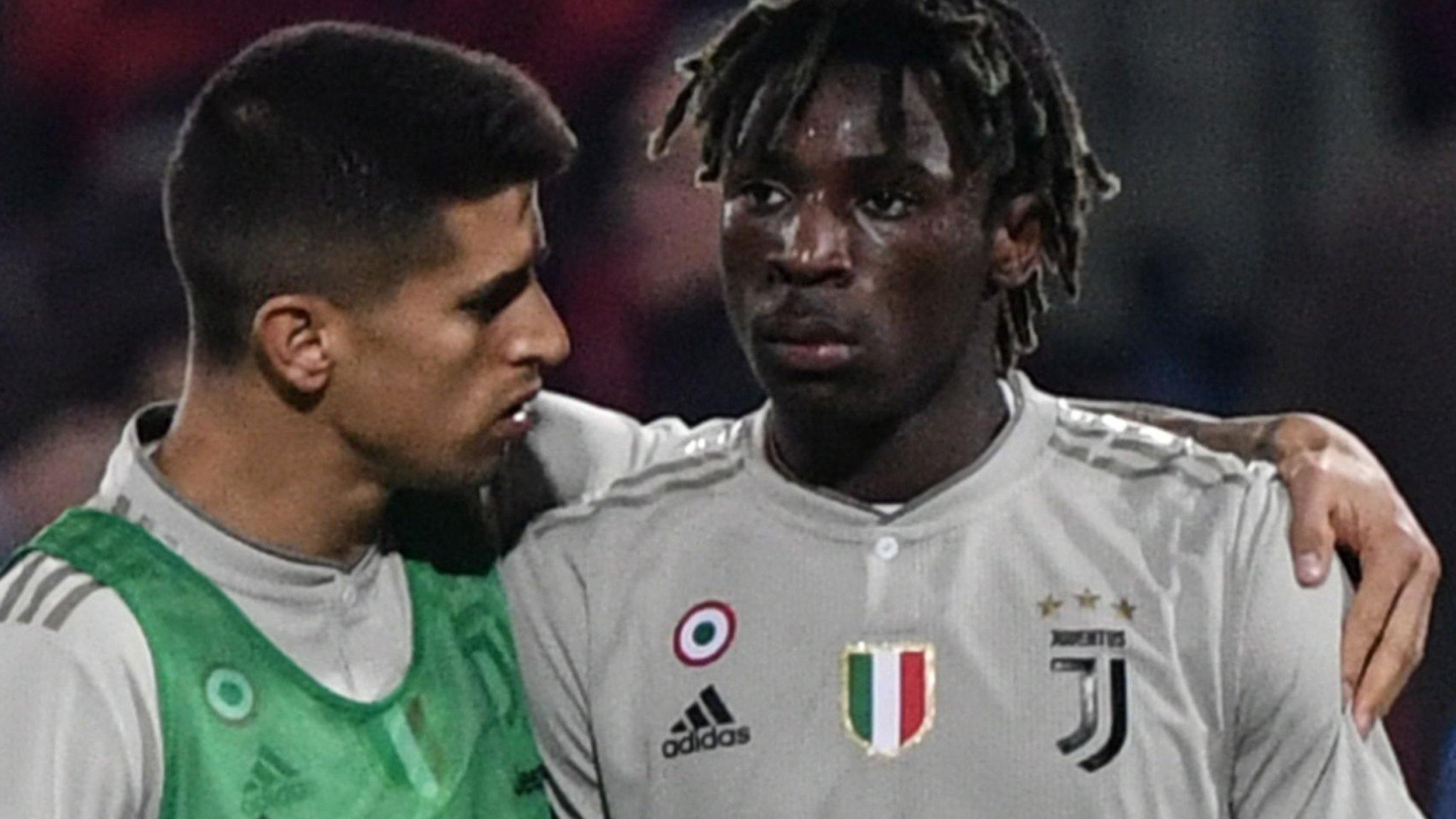 Juventus forward Moise Kean is consoled by team-mate Joao Cancelo after being racially abused during a Serie A match in Cagliari