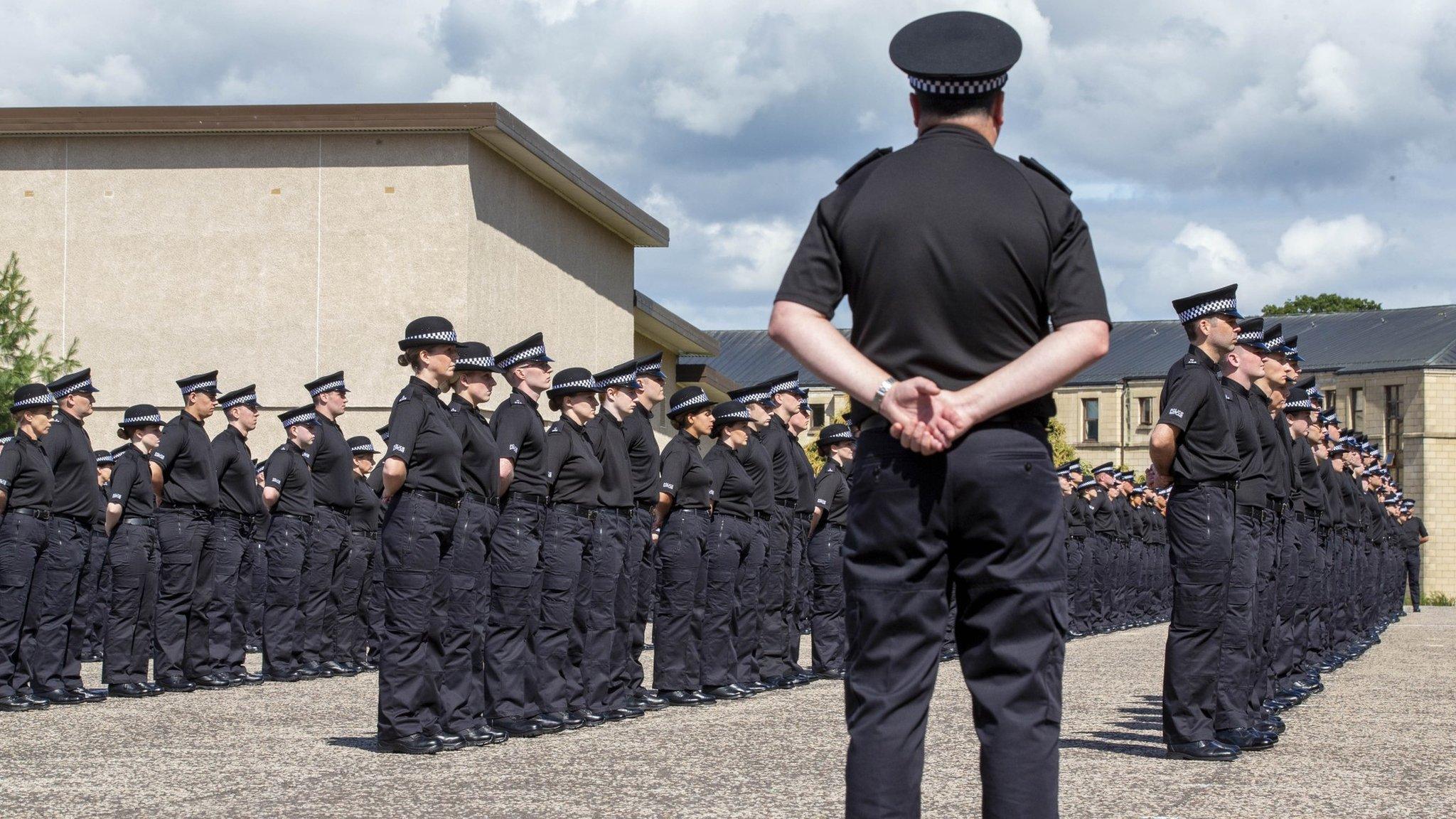 New police officers taking the oath of office at the force's headquarters in July