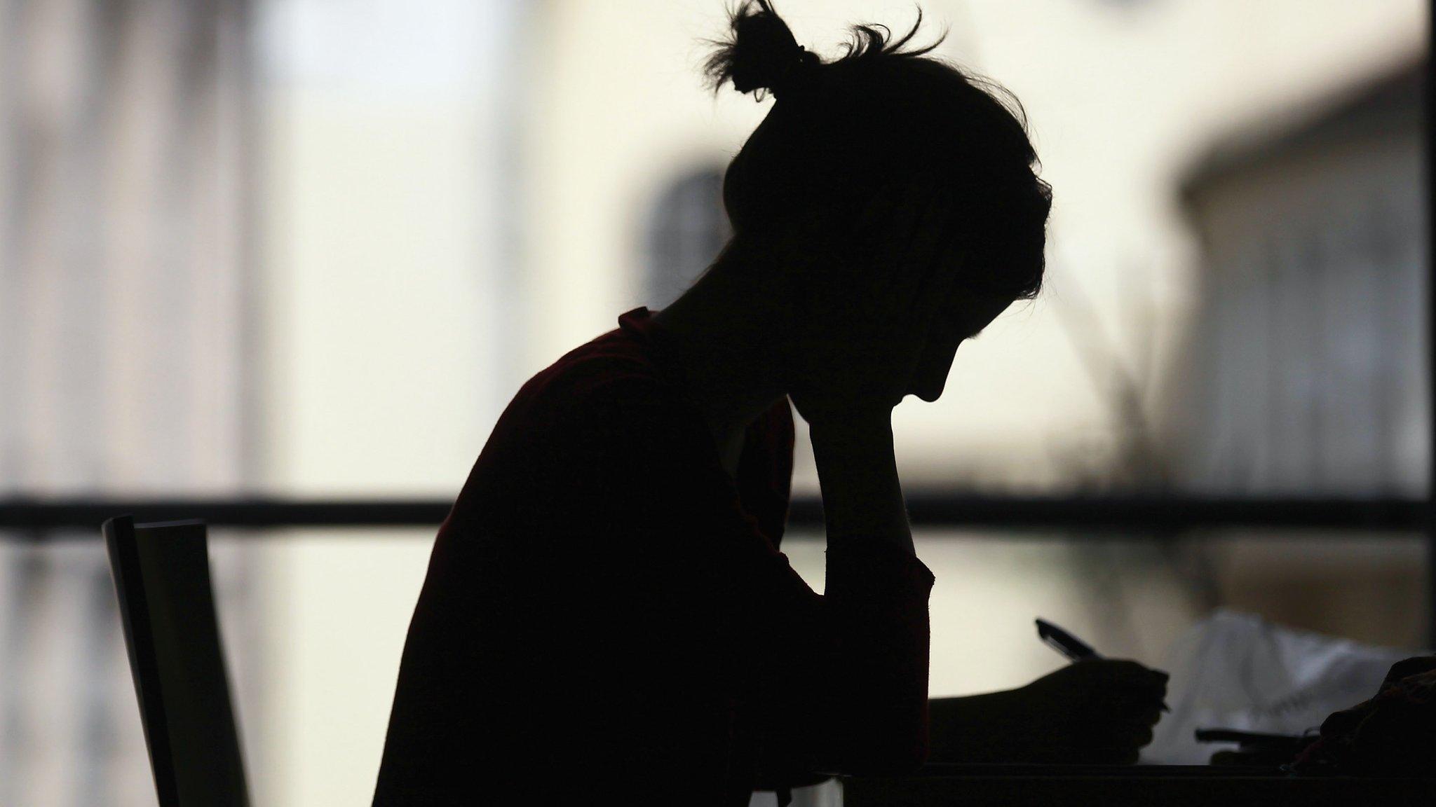 Female writing in a library