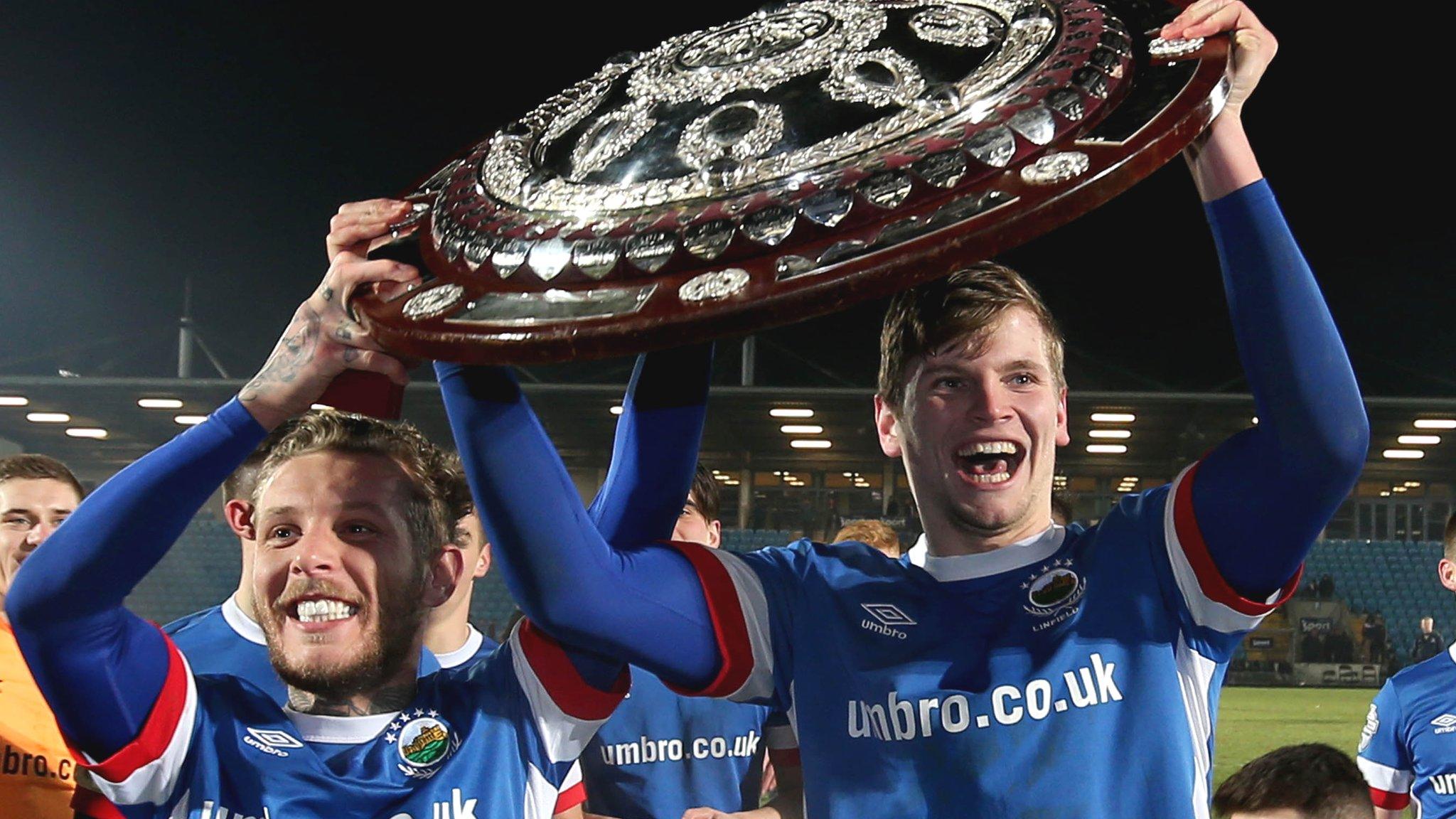 Linfield pair Kirk MIllar and Cameron Stewart celebrate with the Co Antrim Shield