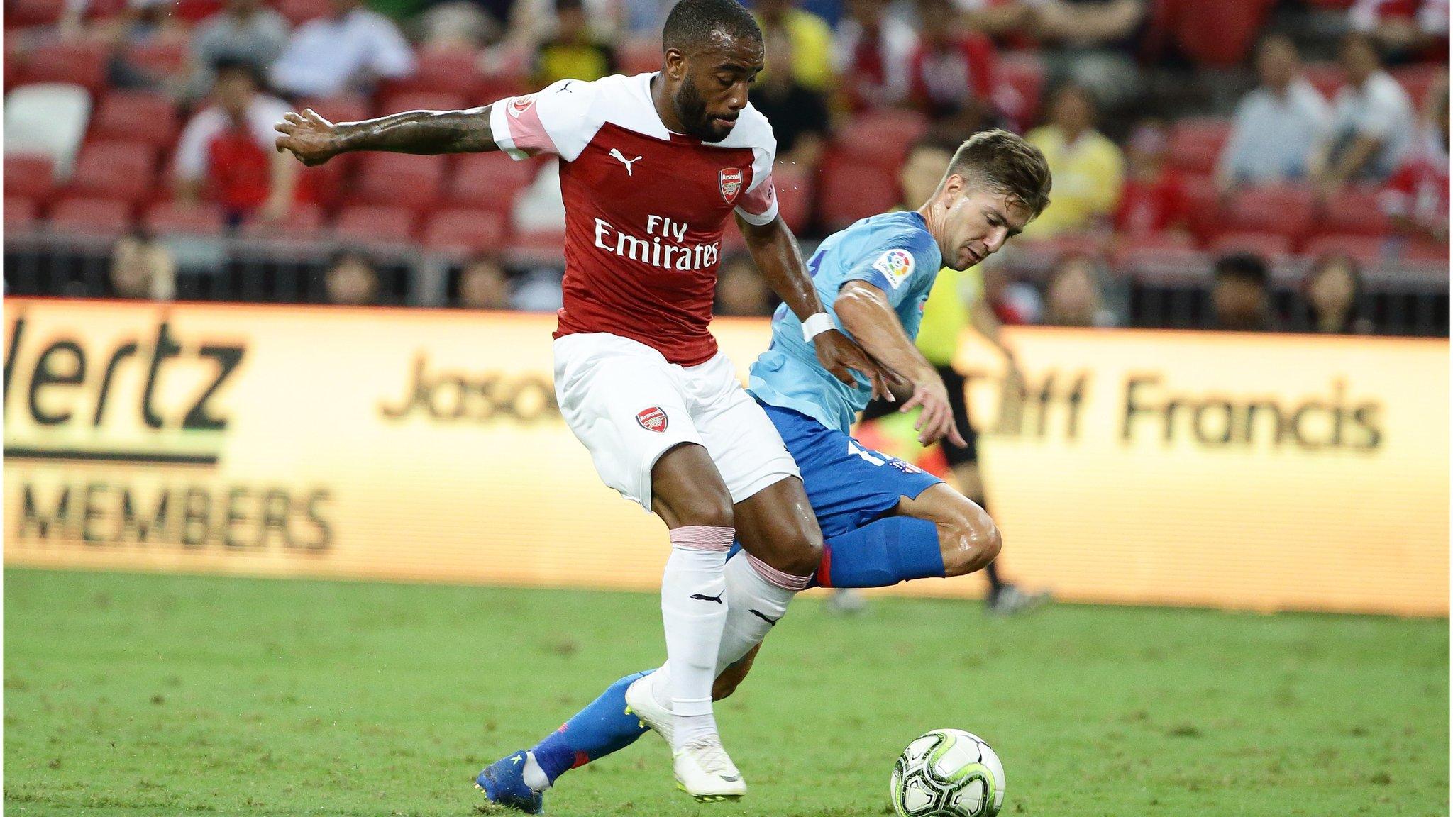 Alexandre Lacazette of Arsenal and Luciano Vietto of Atletico Madrid