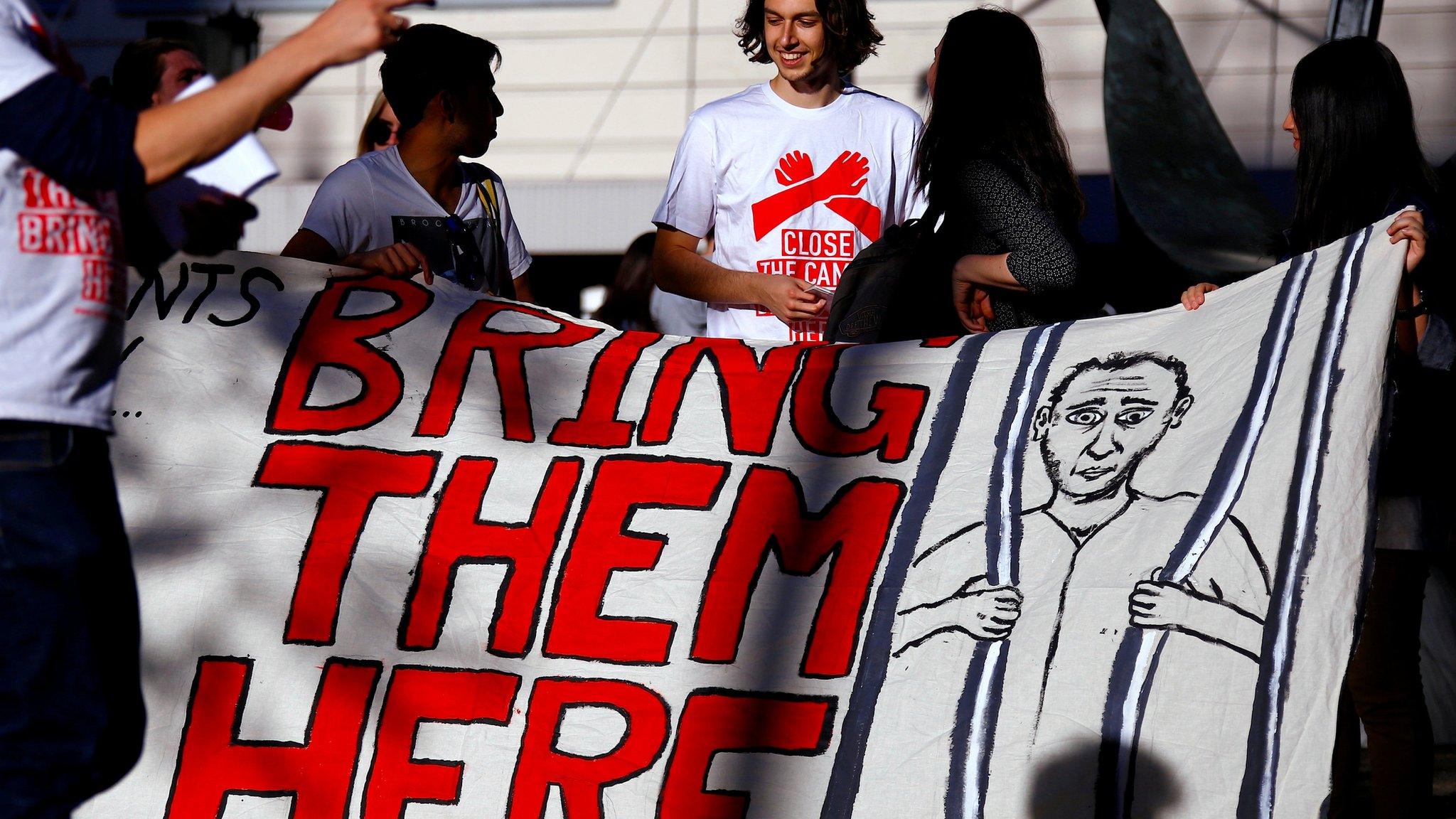 Refugee advocates hold a banner during a protest in central Sydney, Australia, October 5, 2016