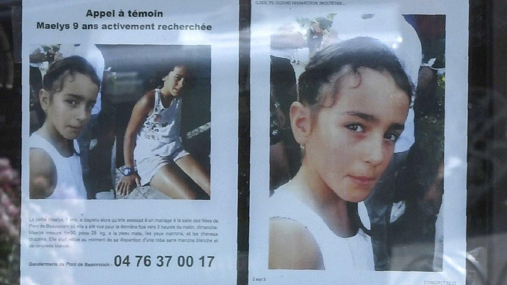 Woman looks at a poster for Maëlys de Araujo in Pont-de-Beauvoisin, eastern France, on August 28, 2017