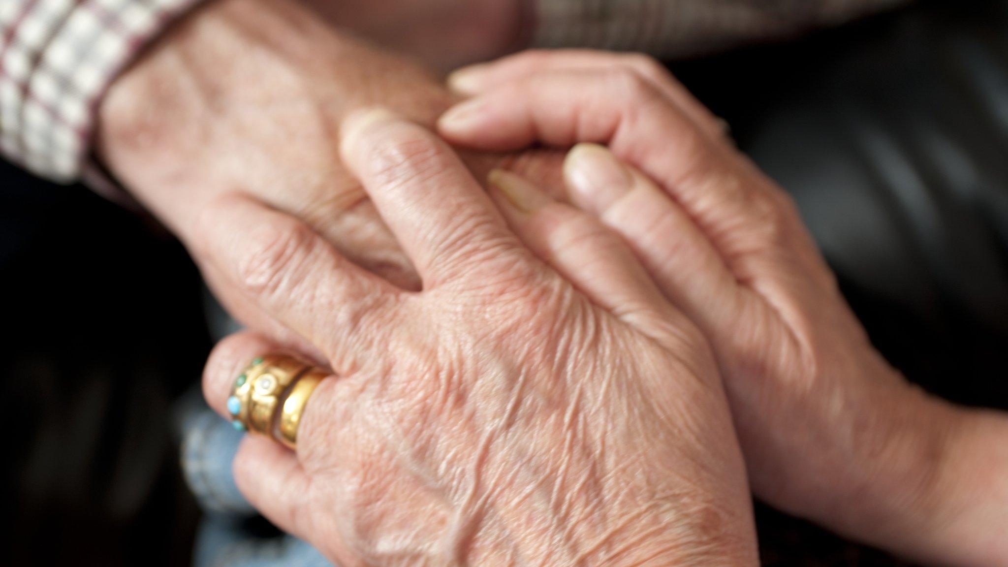 A dementia patient being comforted by a relative