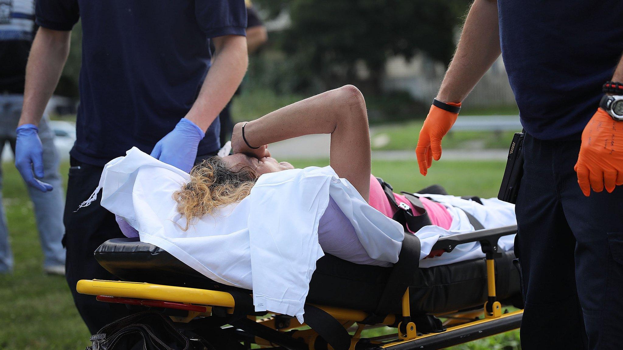 Medical workers and police treat a woman who has overdosed on heroin on July 14, 2017 in Warren, Ohio