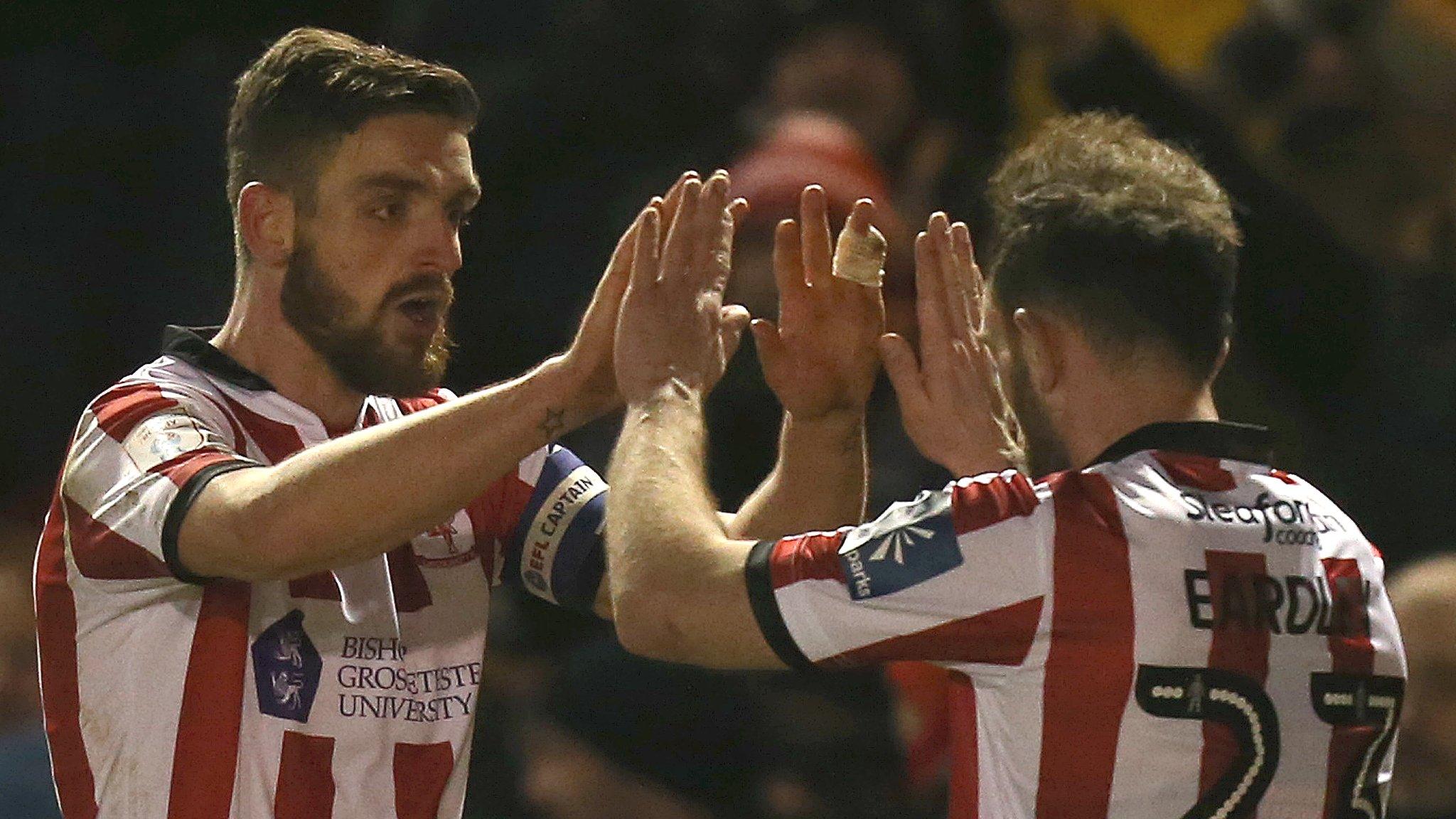 Lincoln captain Luke Waterfall (left) celebrates his goal with Neal Eardley