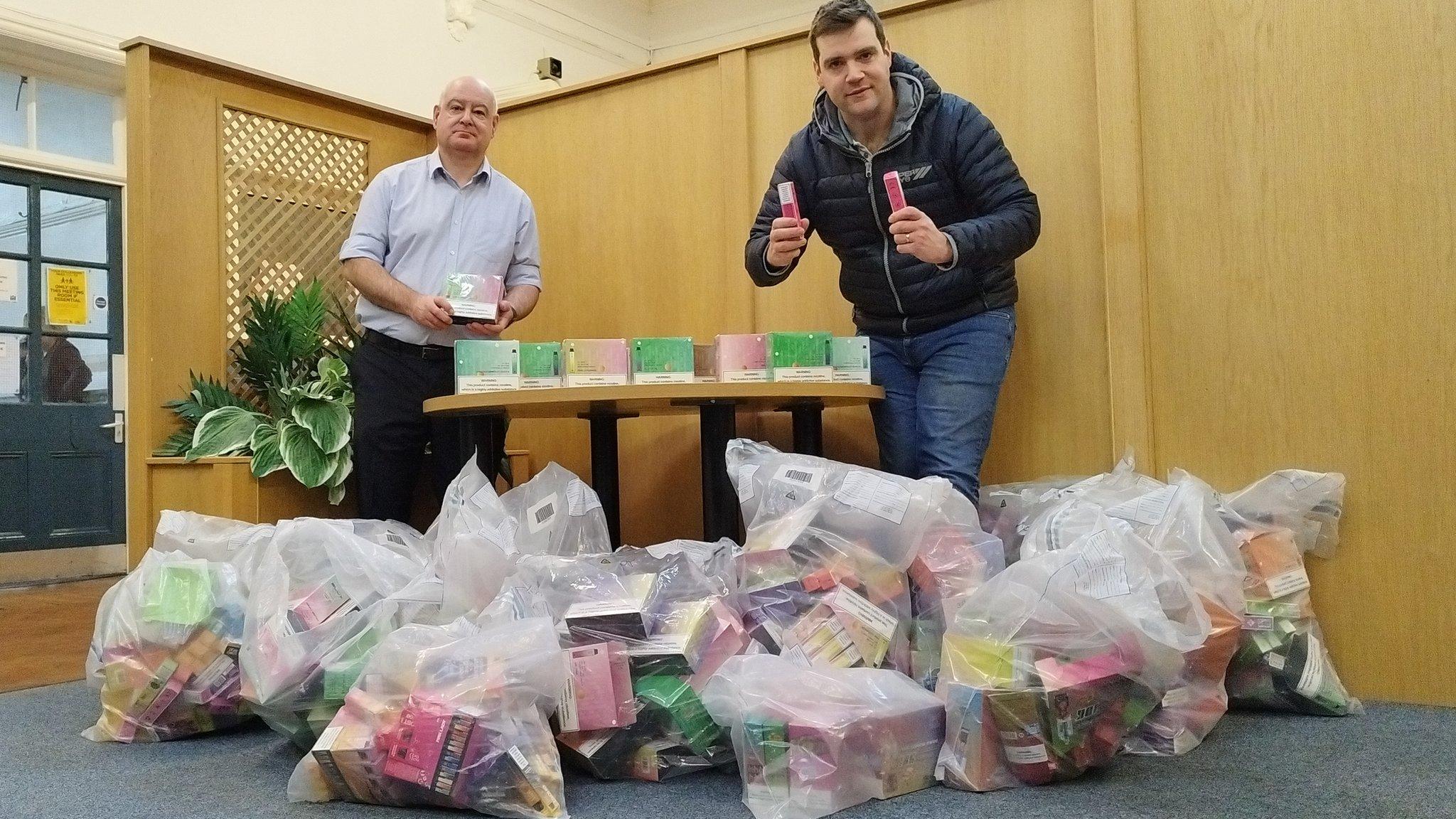 Shaun Trevor and Cllr Mike Renton will bags of seized vapes