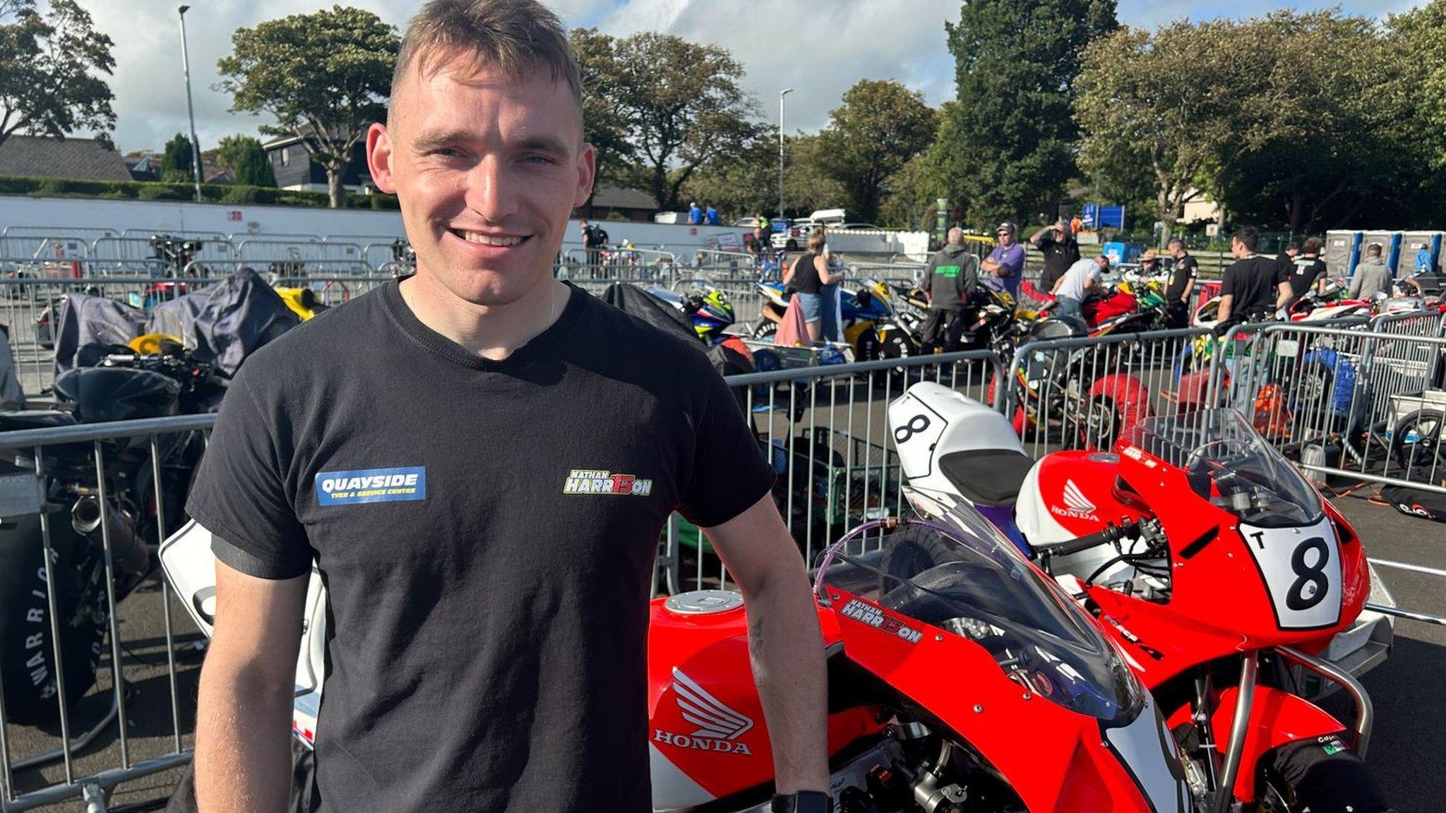 Nathan Harrison standing next to his bikes