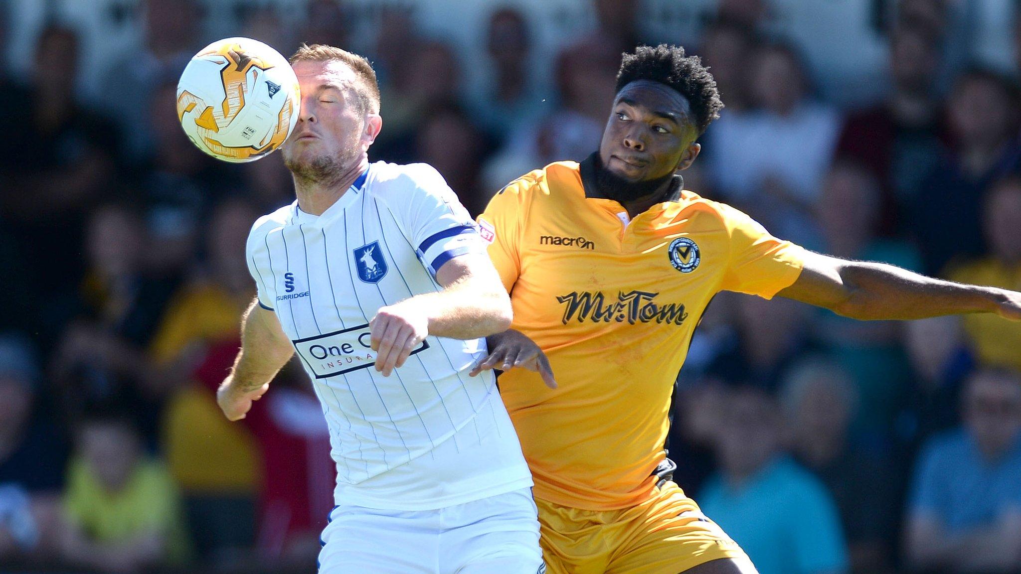 Lee Collins of Mansfield Town battles for the ball with Marlon Jackson