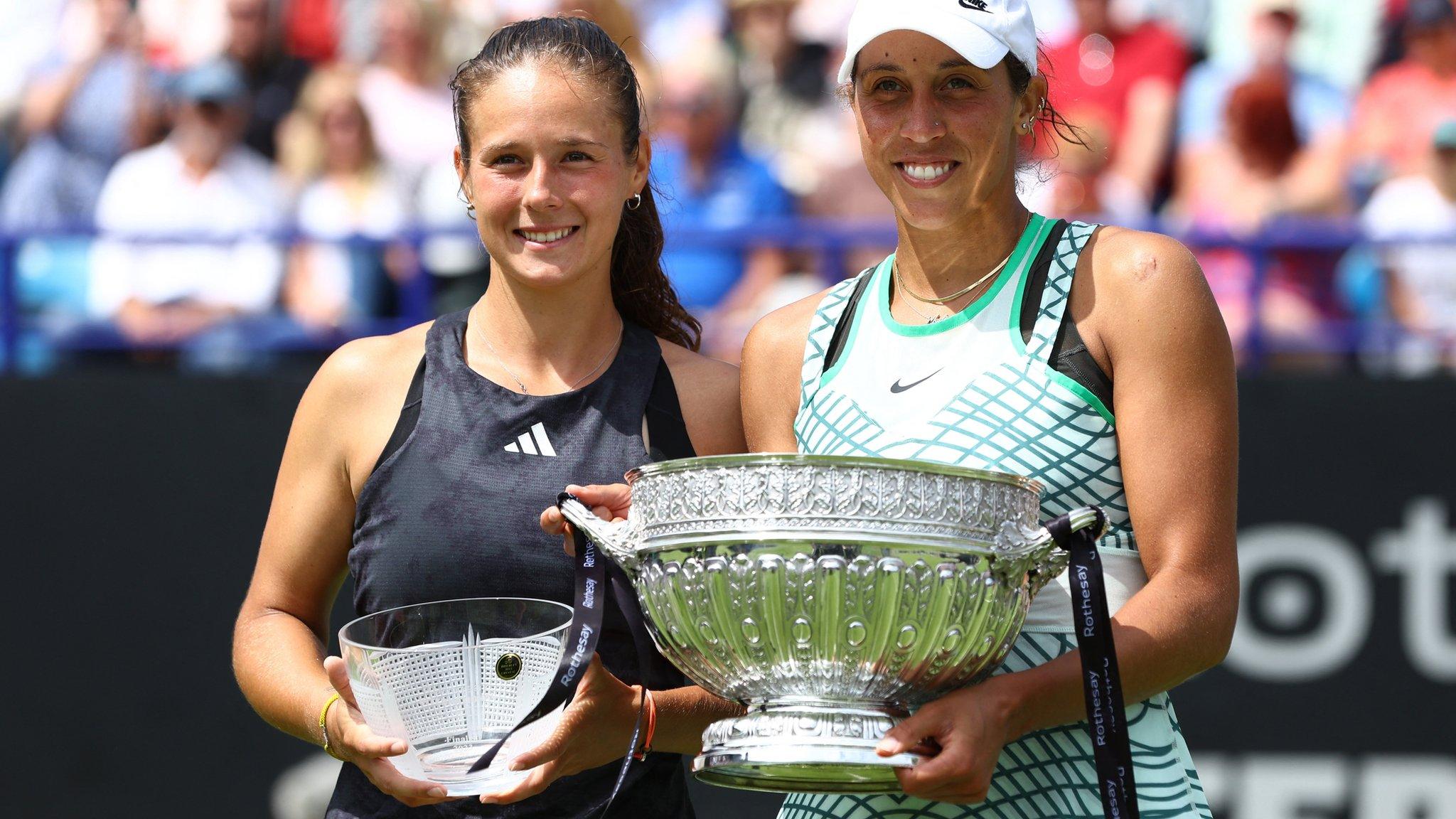 Madison Keys lifts the Eastbourne trophy alongside Daria Kasatkina