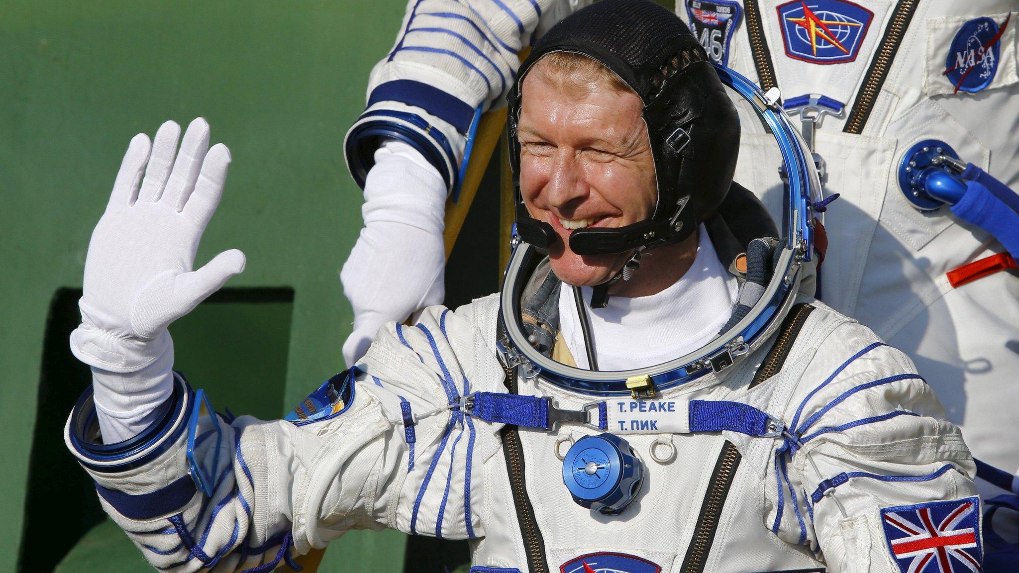 Tim Peake waves as he boards the Soyuz spacecraft