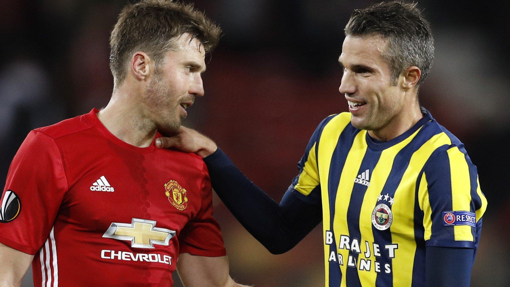 Manchester United's Michael Carrick shakes hands with former team mate Robin van Persie