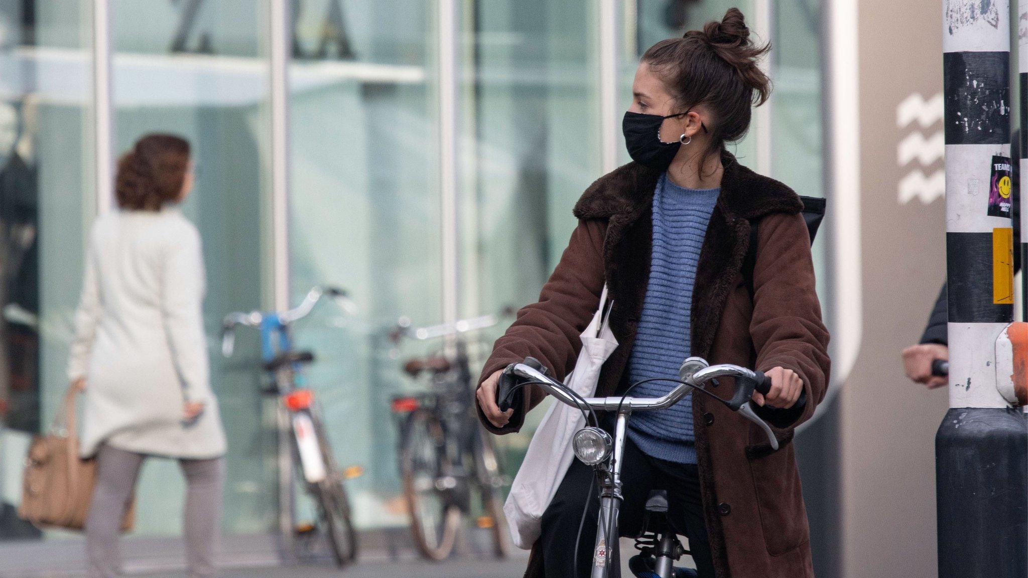 Daily life in Eindhoven city in the Netherlands with people wearing facemask as they are outside