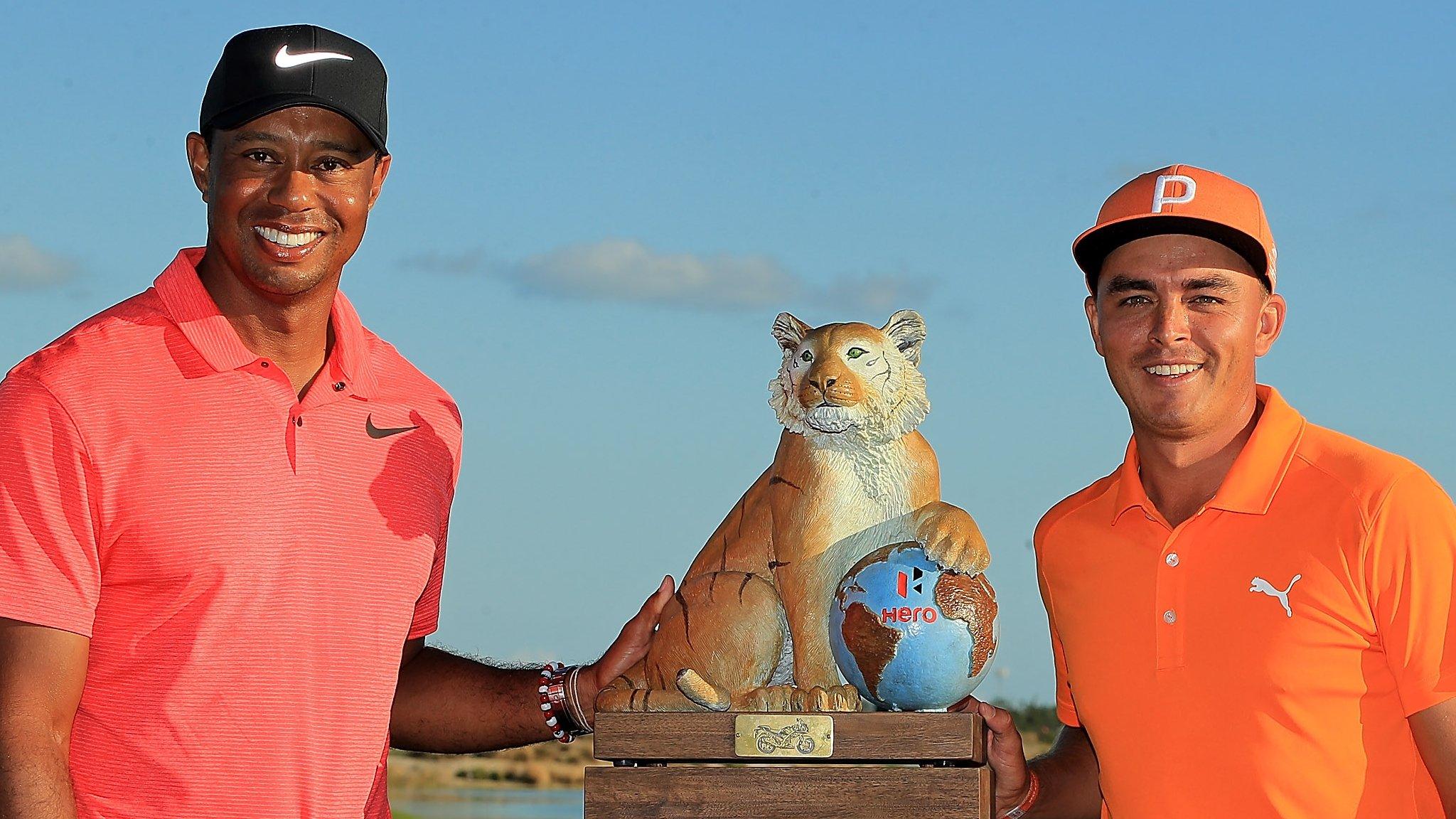 Tiger Woods and Rickie Fowler smile with the Hero World Challenge trophy