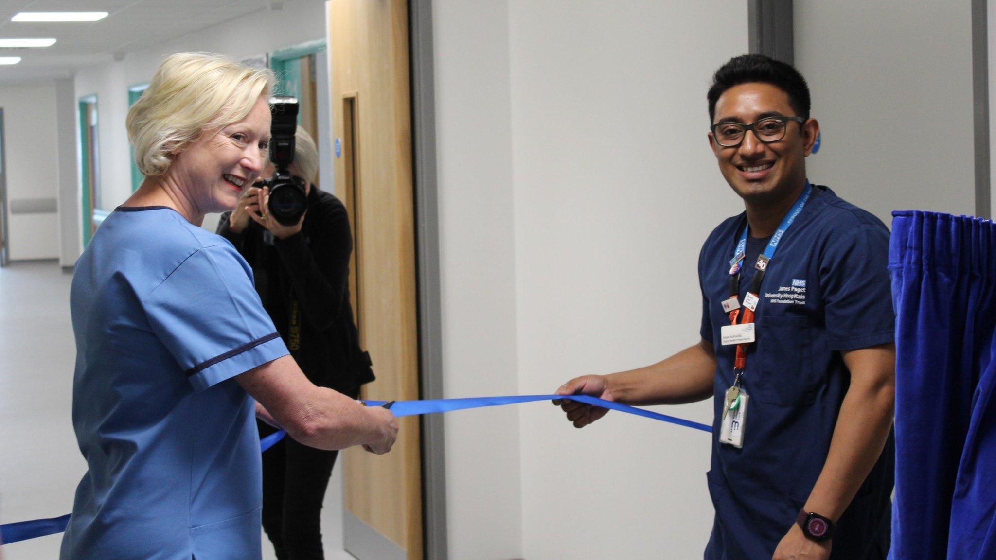 Dame Ruth May and Isaac Kuruvilla cutting ribbon at James Paget University Hospital