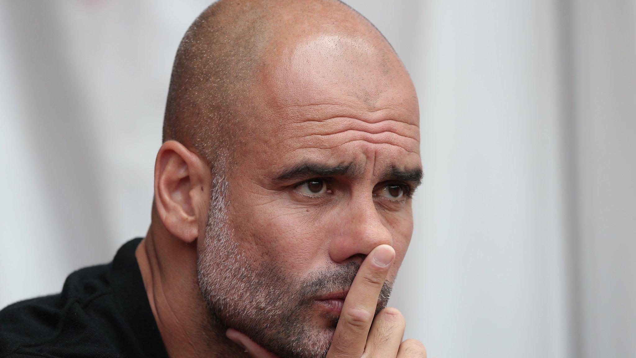 Man City manger Pep Guardiola watches on