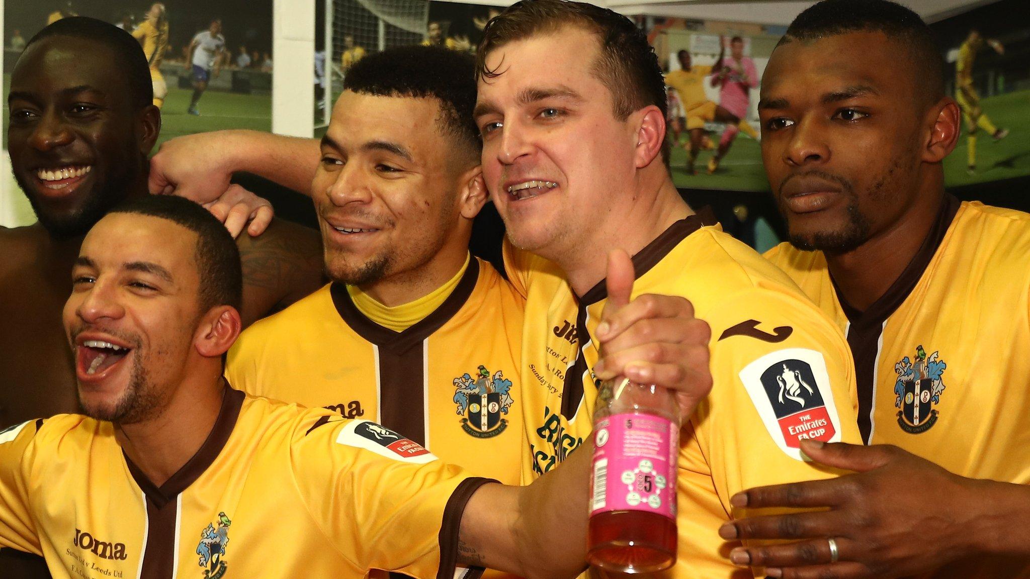 Sutton United's players celebrate after beating Leeds United in the FA Cup