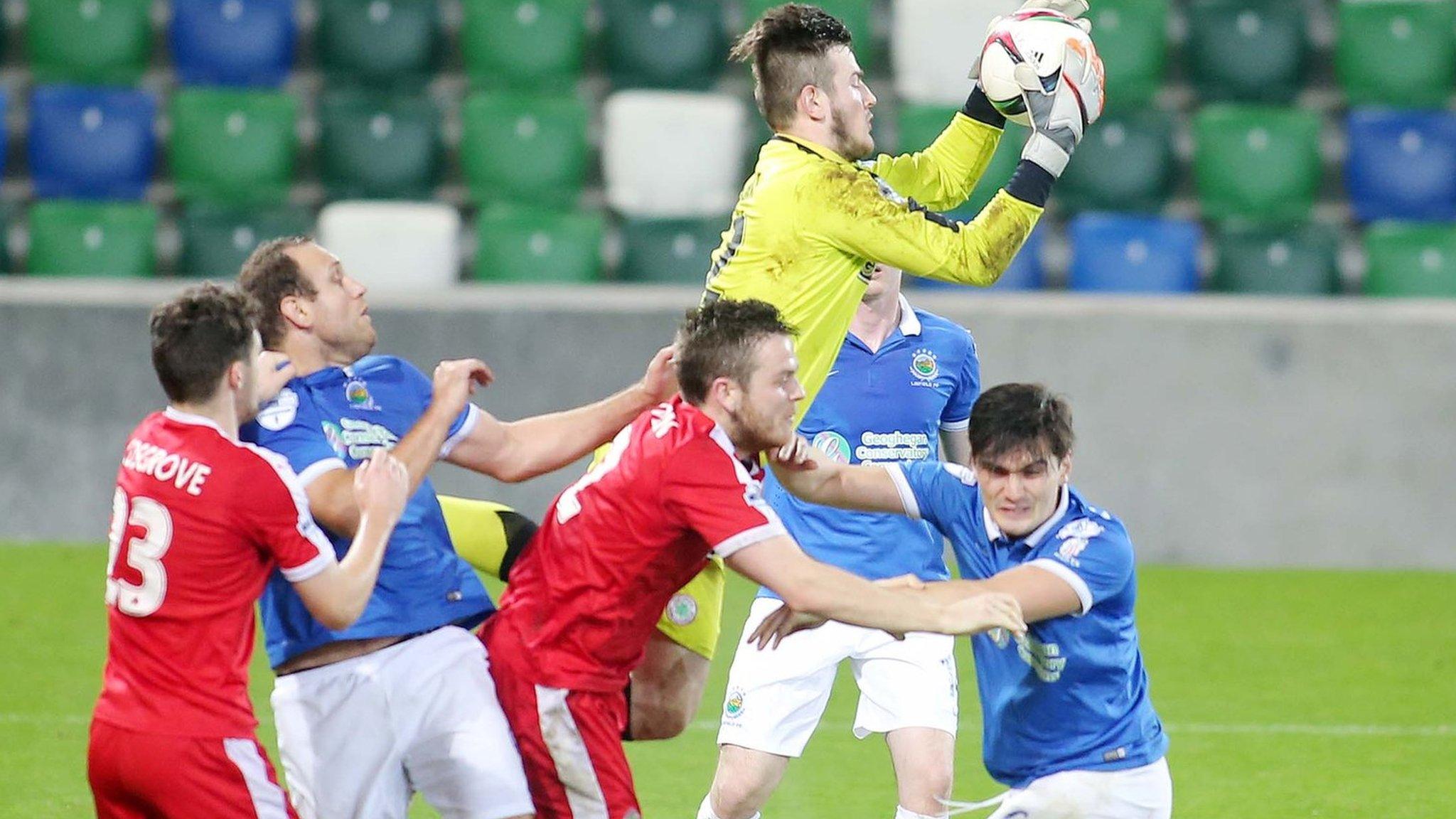 Cliftonville keeper Peter Burke rises highest to collect the ball against Linfield