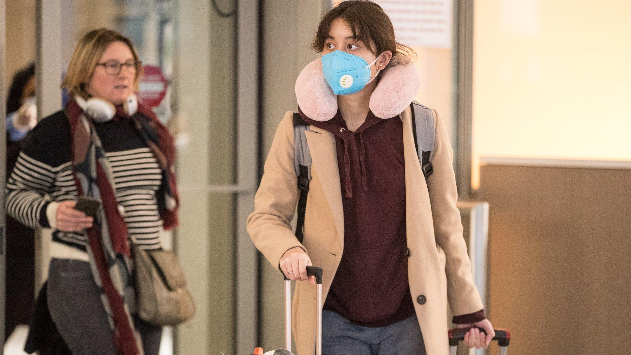 Passengers arrive in the international terminal at Logan Airport on March 13, 2020 in Boston, Massachusetts.