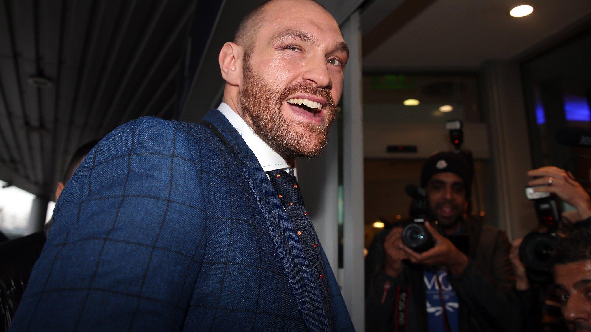 Tyson Fury arrives at a news conference in Bolton