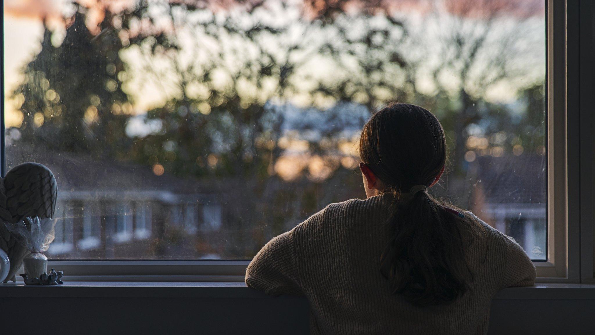 girl looking out window