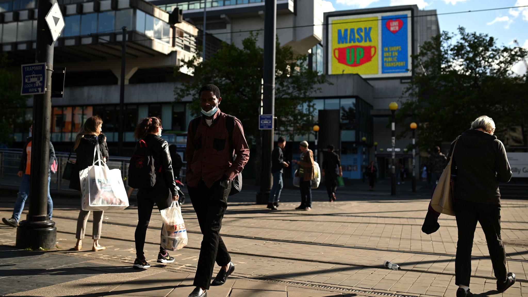 A person wears a mask in Manchester City Centre