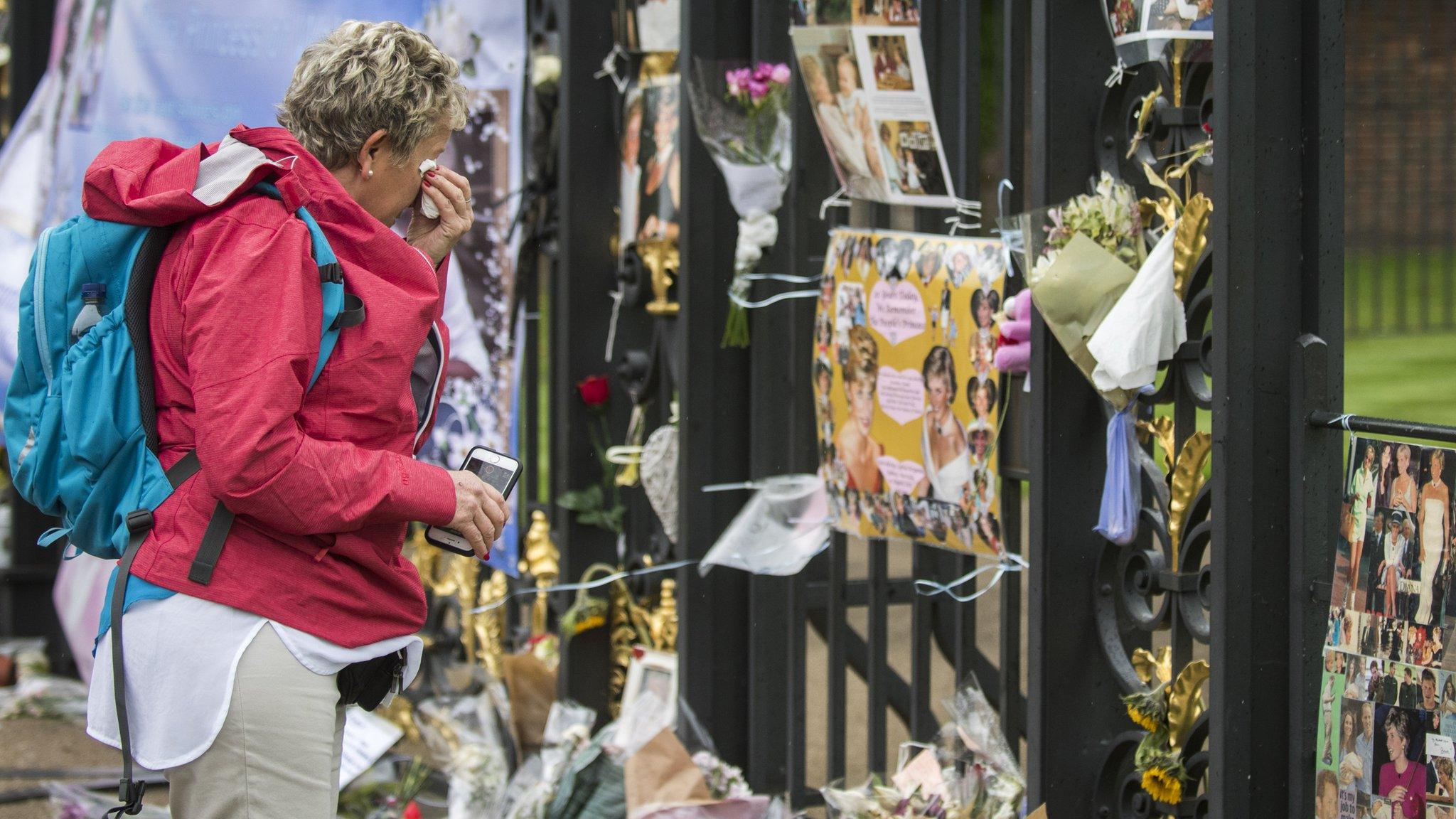 Woman cries by the tributes