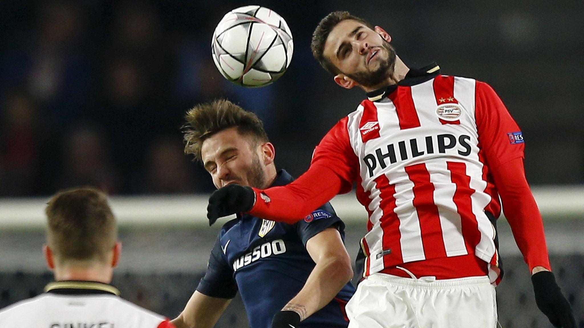 PSV Eindhoven's Gaston Pereiro challenges with Atletico Madrid's Saul Niguez