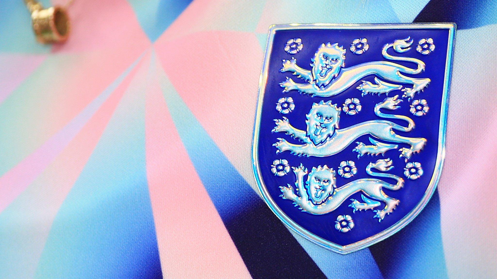 The shiny Three Lions badge on the England warm-up shirt is seen before the Women's International friendly match between England and Belgium