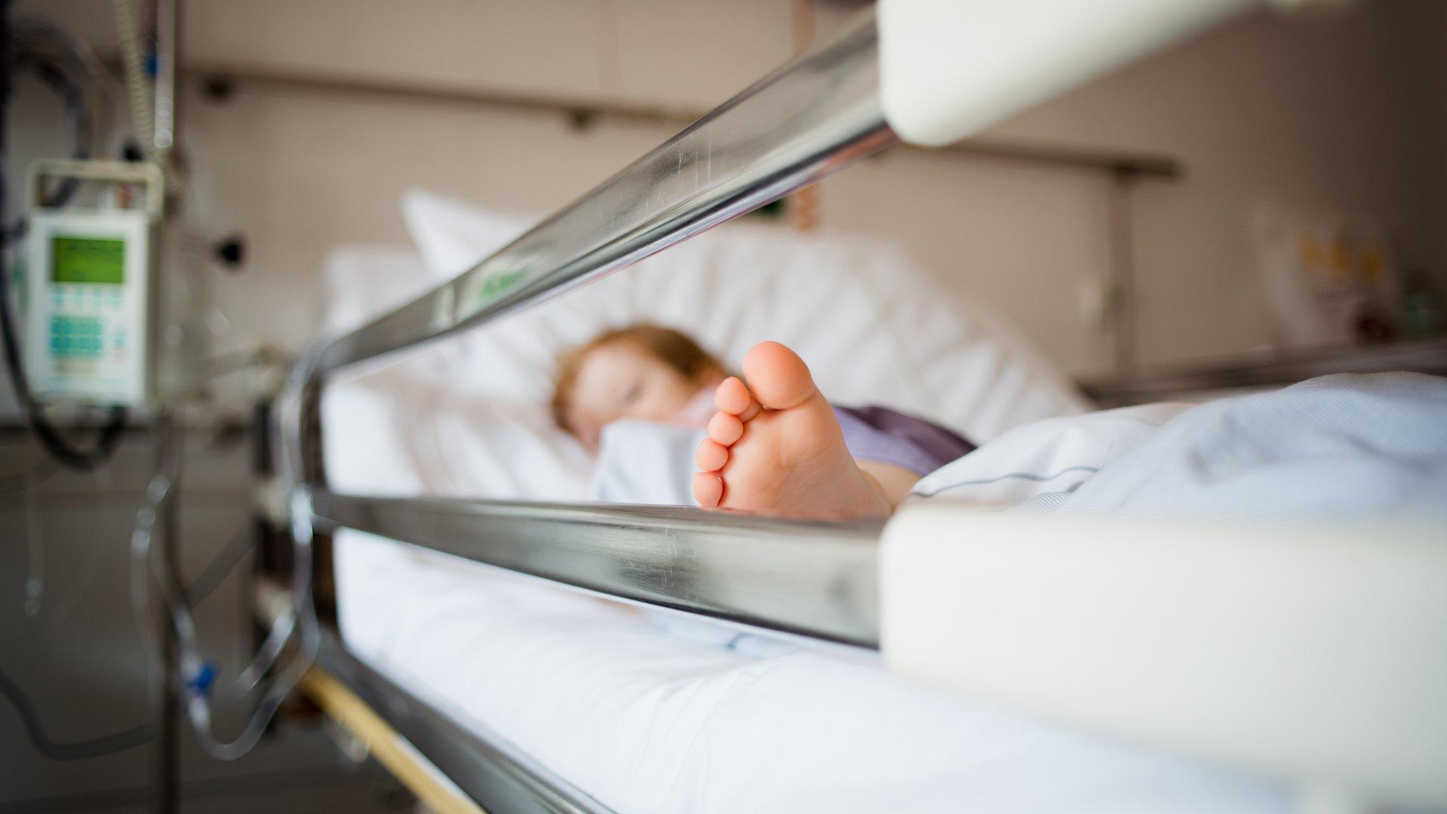 Young girl lying in a hospital bed