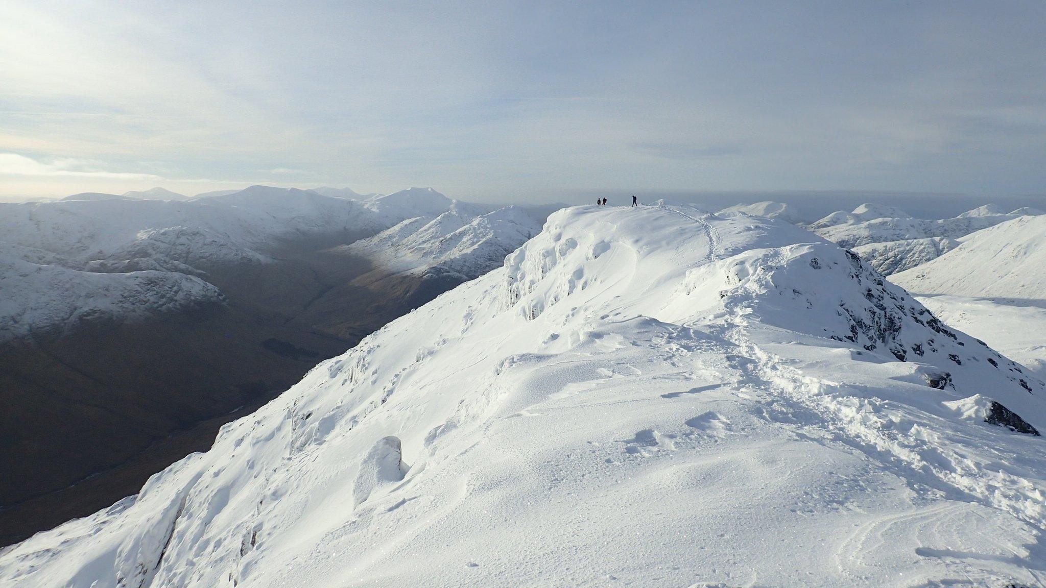 Hillwalkers in snow in Glencoe