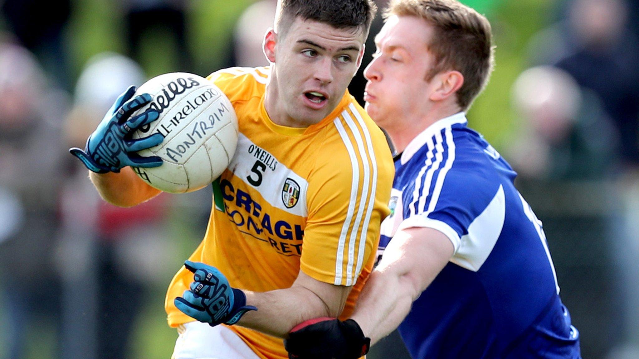 Antrim forward Paddy McBride is tackled by Paul Kingston of Laois