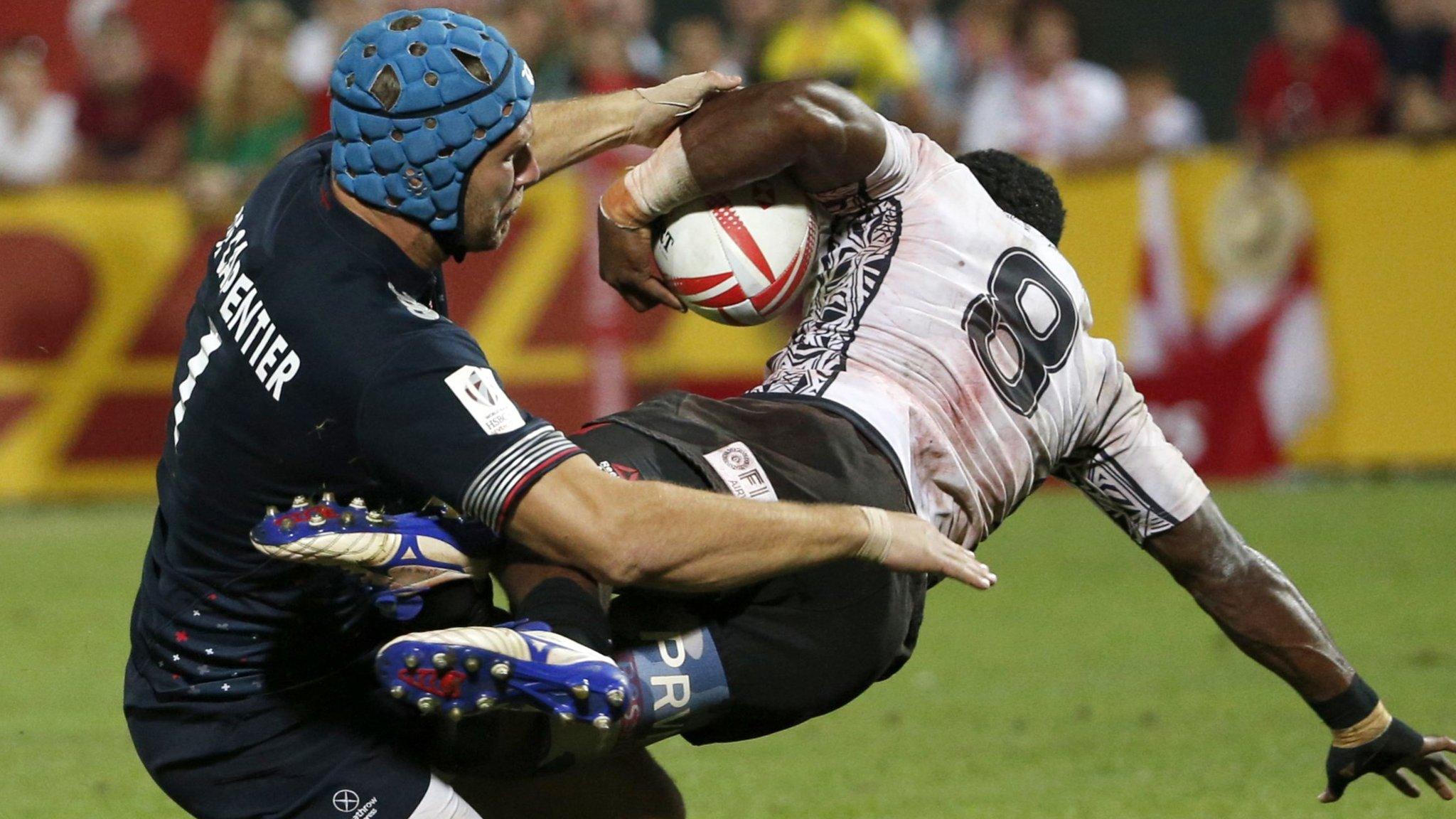 Jerry Tuwai (right) is tackled by Englands Richard de Carpentier