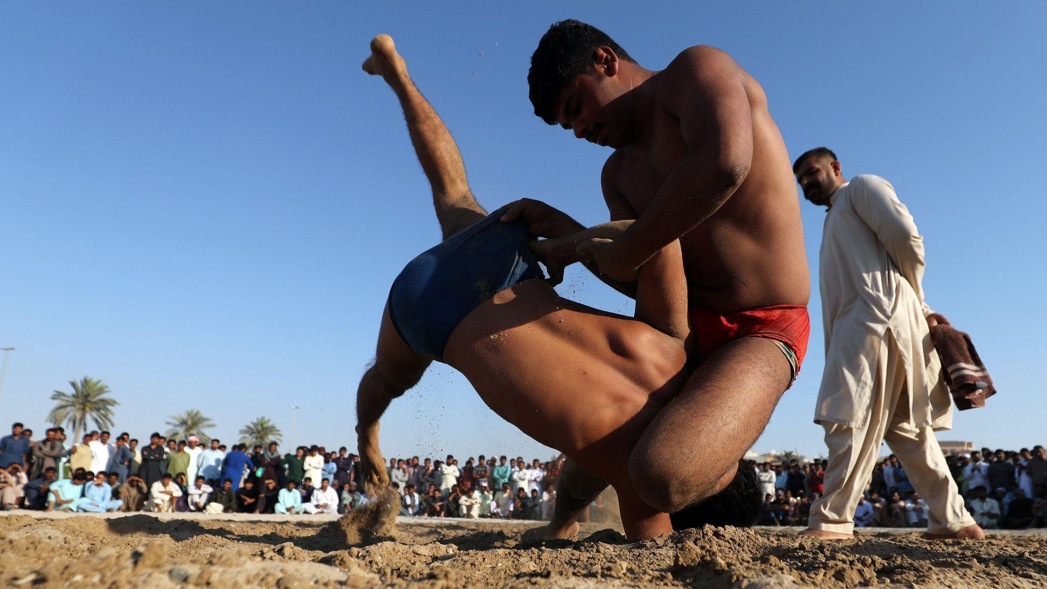 Pakistani men compete in a weekly Graeco-Roman wrestling competition in Dubai on March 16, 2018