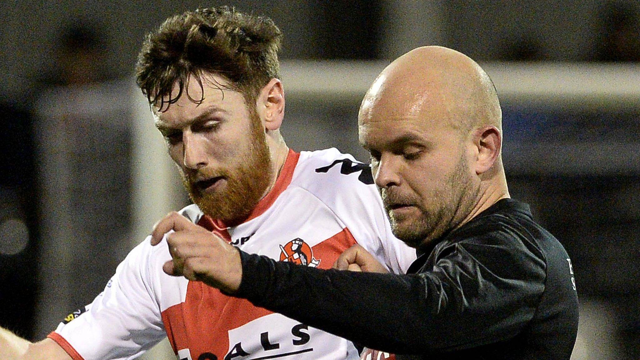 Coleraine's Howard Beverland battles with PSNI's Lukasz Adamczyk at Seaview