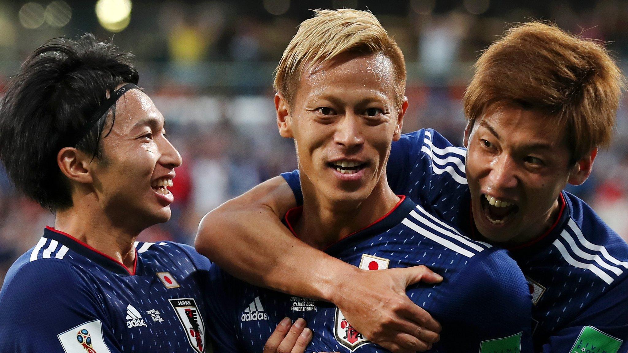 Japan's players celebrate scoring against Senegal at the 2018 World Cup