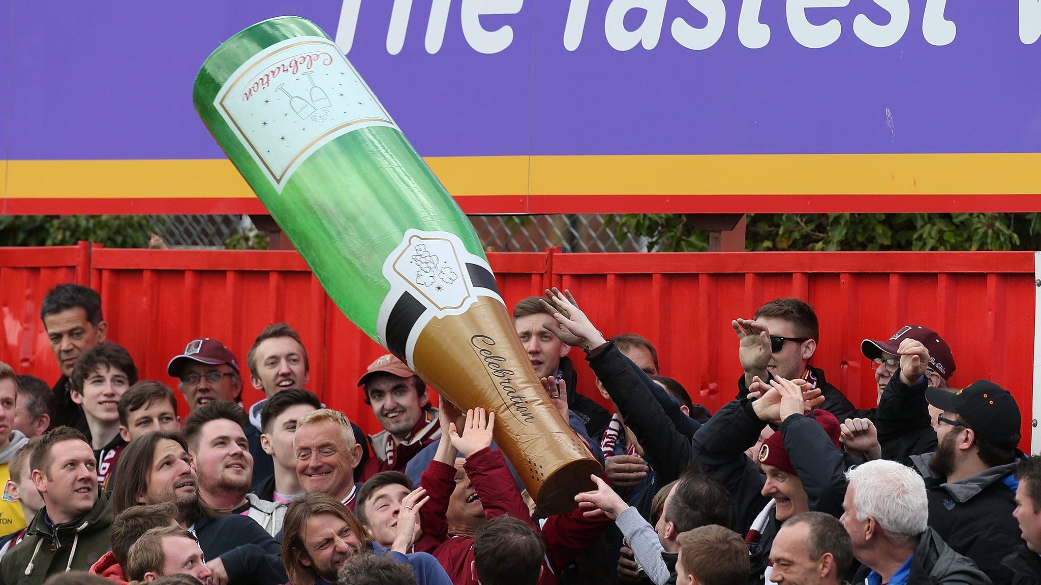 Football fans with an inflatable during a match