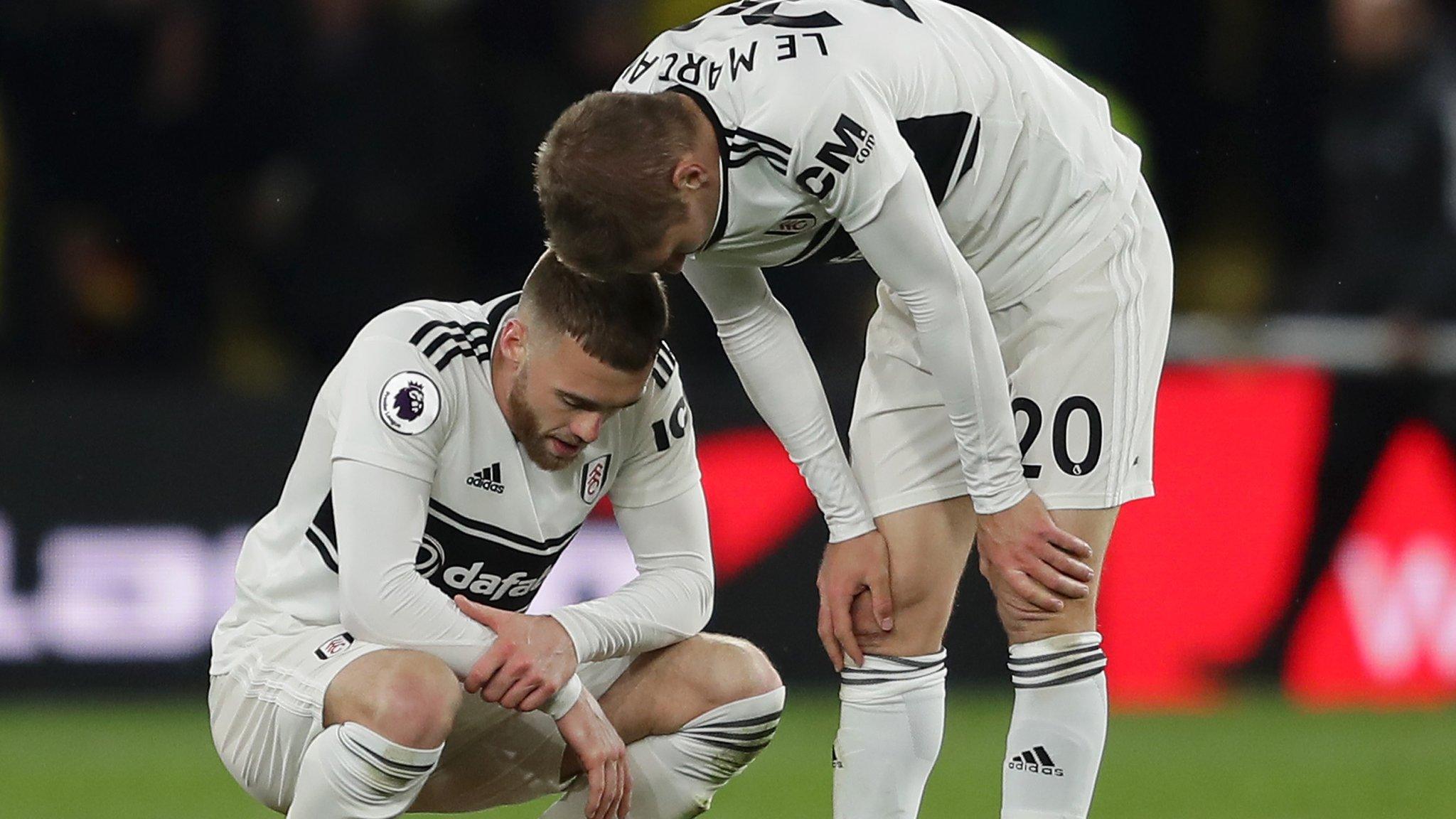 Fulham players Calum Chambers and Maxime Le Marchand look dejected after their relegation from the Premier League is confirmed