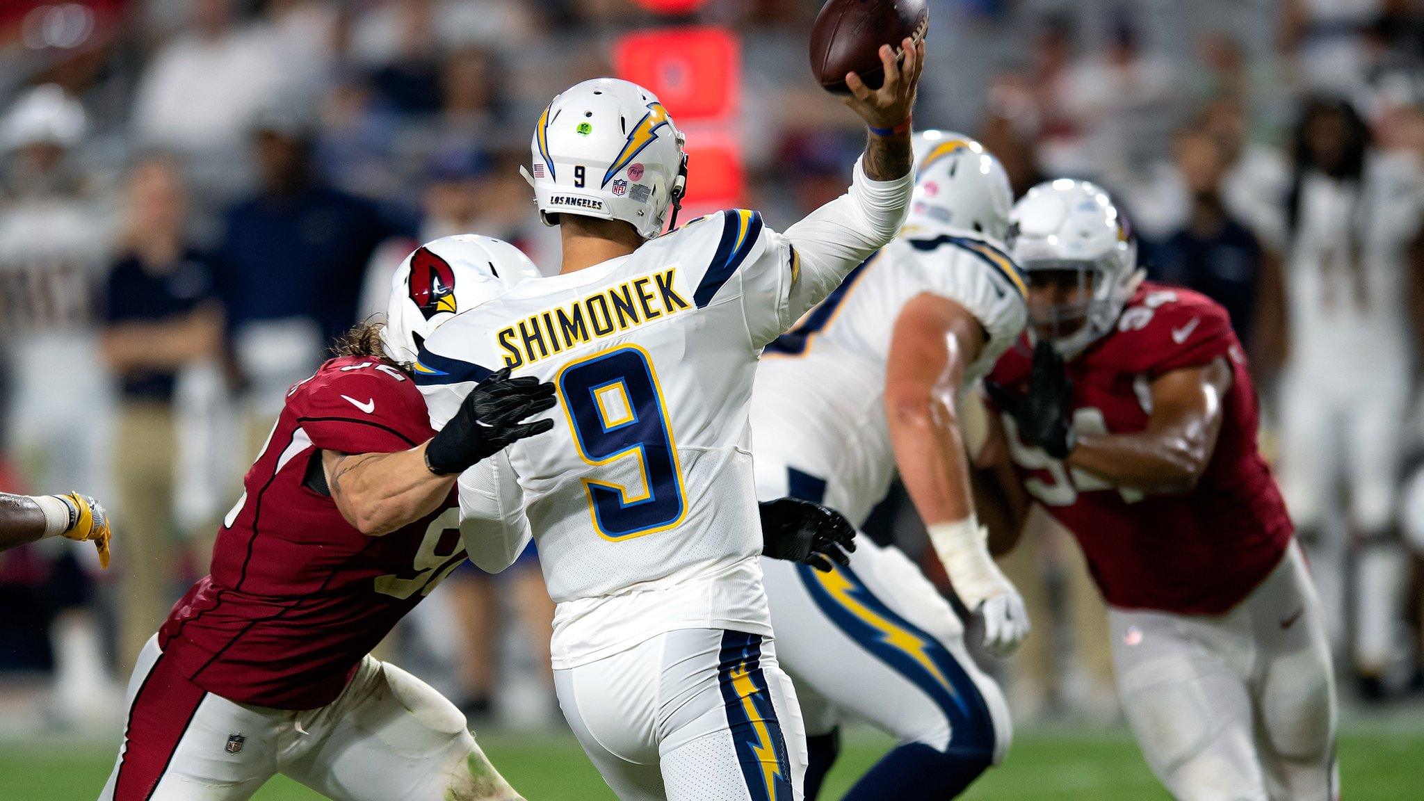 GLENDALE, AZ - AUGUST 11: Los Angeles Chargers quarterback Nic Shimonek (9) passes under pressure from during the preseason NFL game between the Arizona Cardinals and the Los Angeles Chargers on August 11, 2018 at the University of Phoenix Stadium in Glendale, AZ. The Cardinals defeated the Chargers 24-17. (Photo by Carlos Herrera/Icon Sportswire via Getty Images)