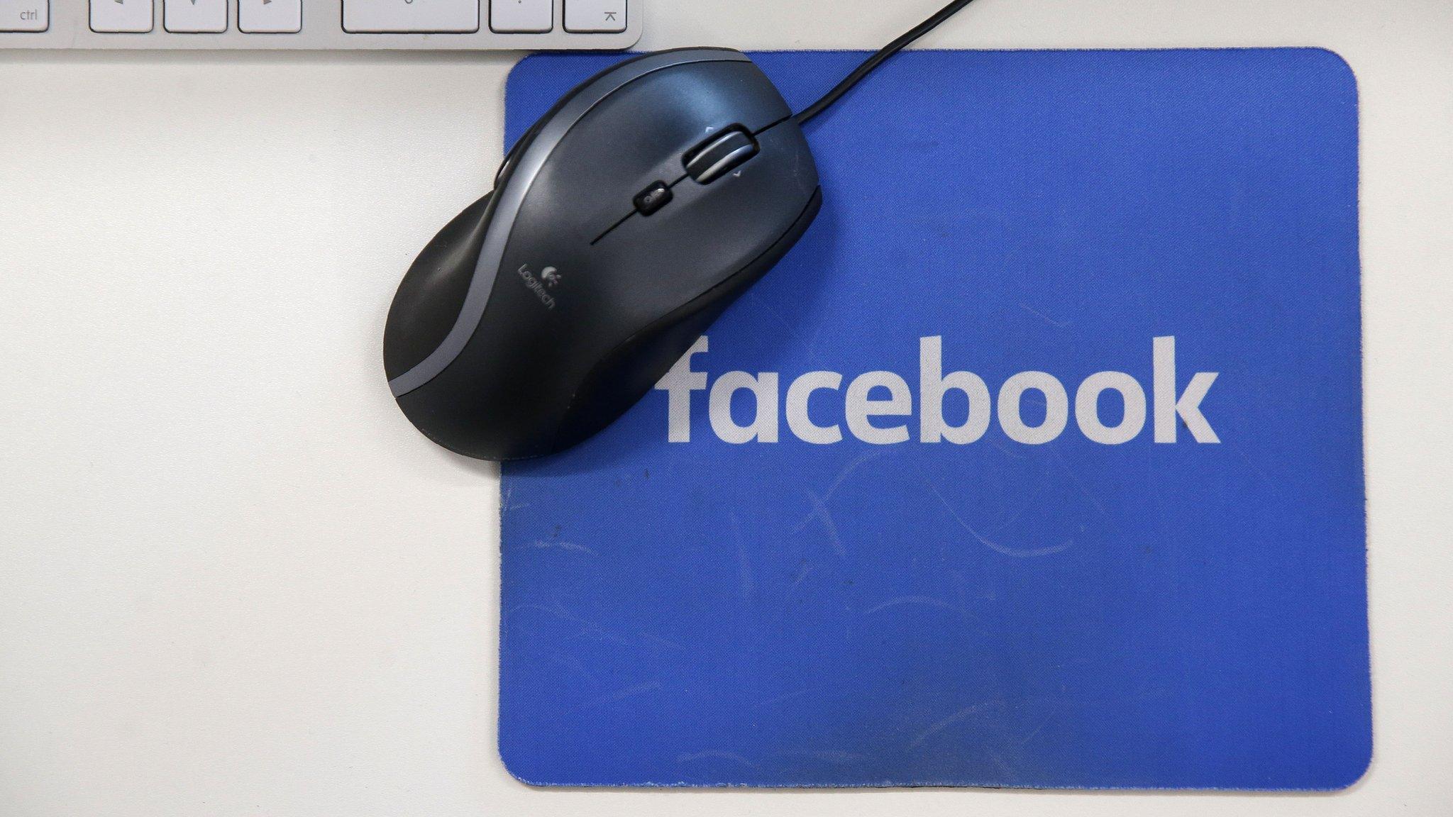 A mousepad with the Facebook logo is seen at Facebook's new headquarters