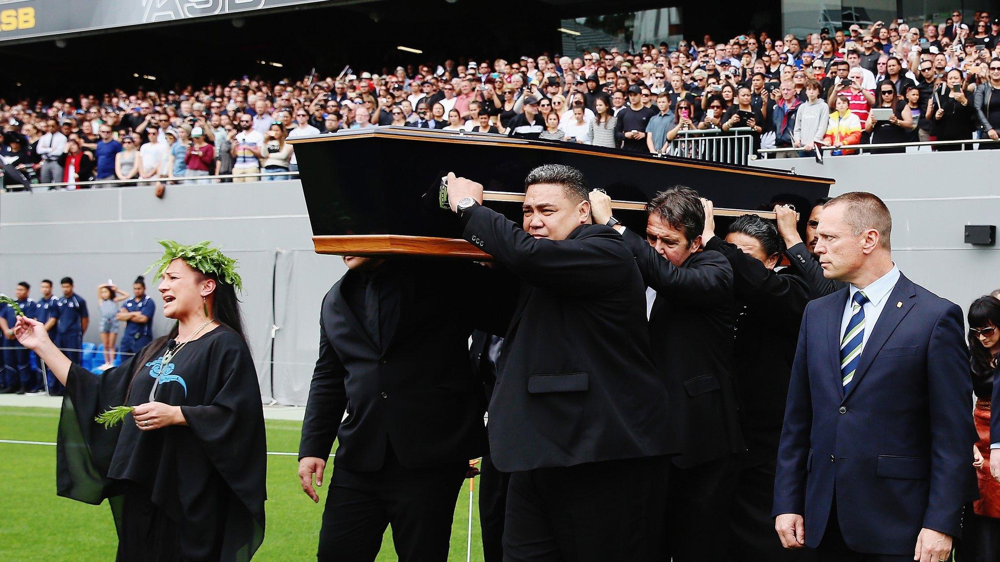 The casket carrying the body of Jonah Lomu is carried onto the field during the memorial for Jonah Lomu