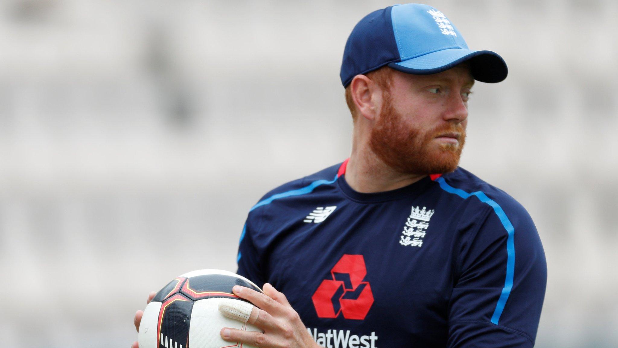 Jonny Bairstow holds a football