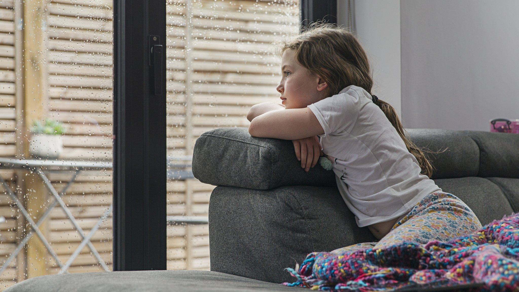 Girl looking out of window