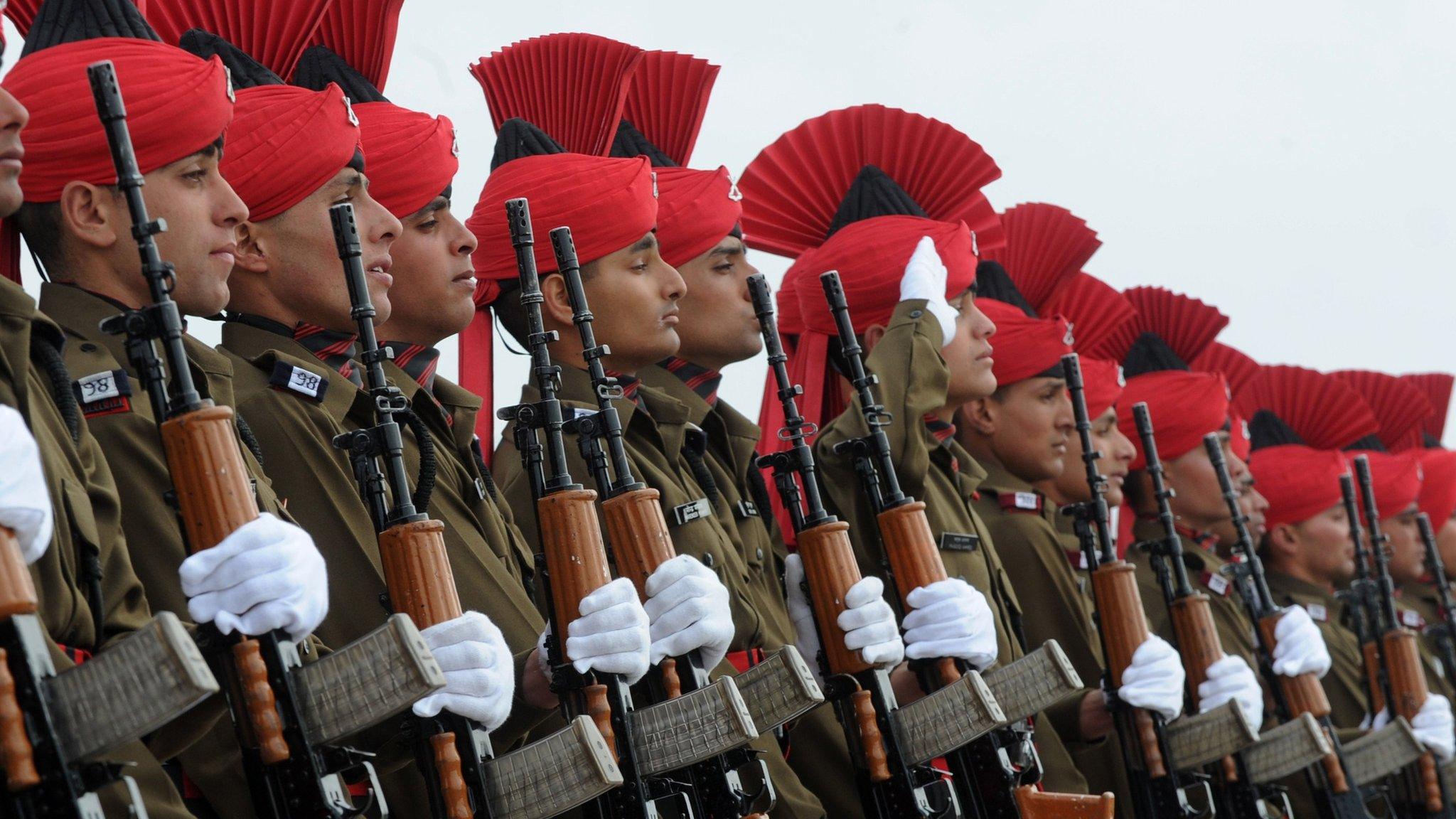 New Indian military recruits stand to attention during a passing-out parade at base on outskirts of Srinagar on March 4, 2015