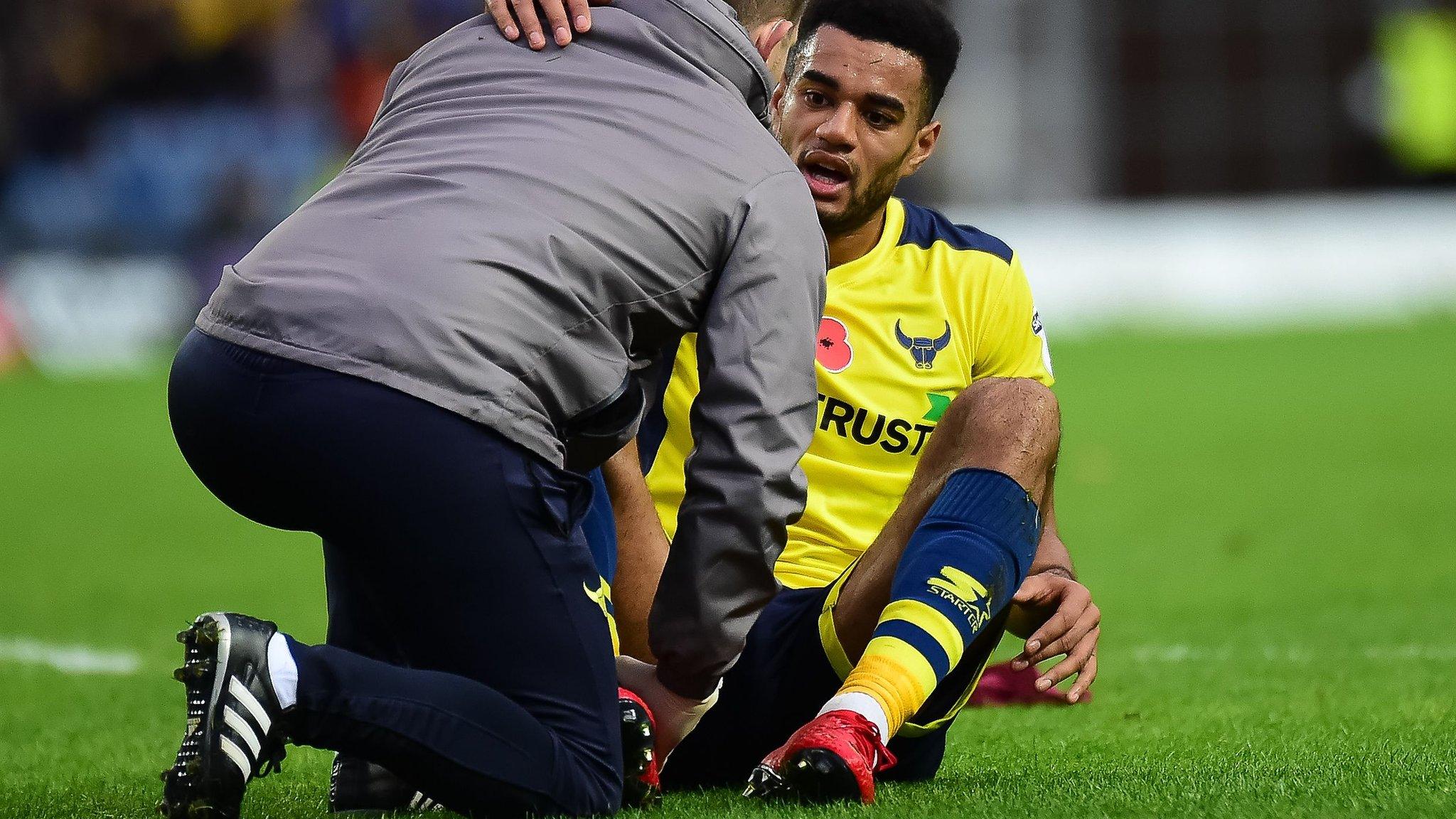 Oxford United captain Curtis Nelson stretchered off