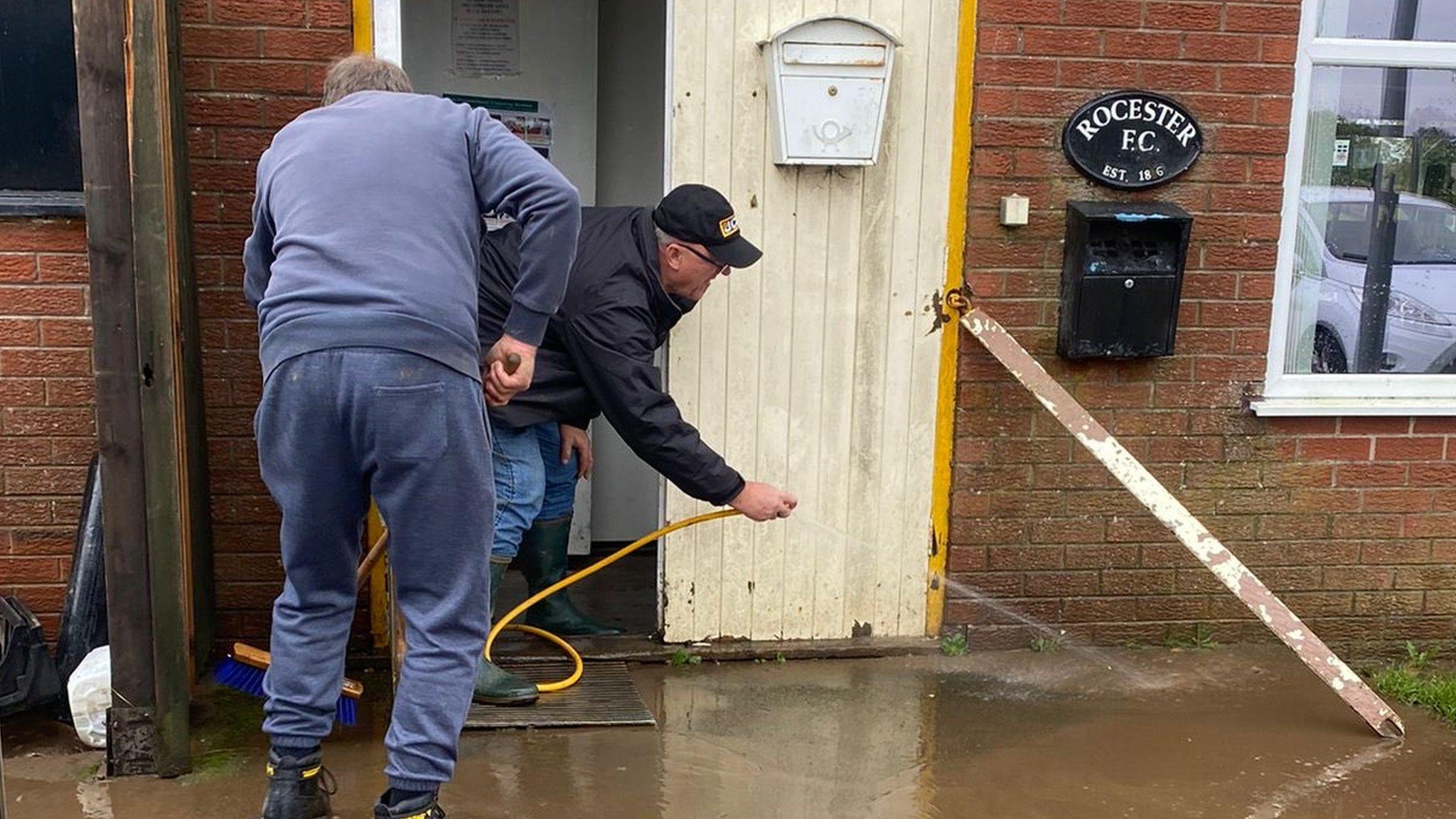 Club volunteers hose away mud