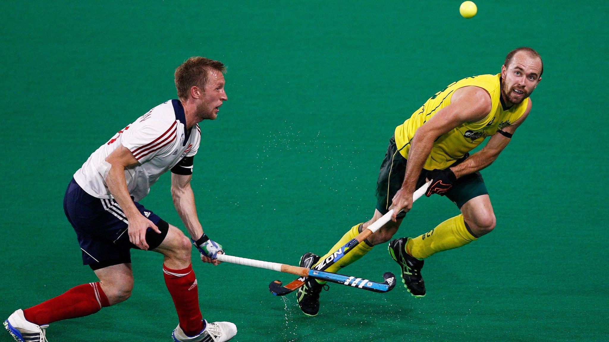 Matthew Swann of Australia battles for the ball with Barry Middleton of Great Britain