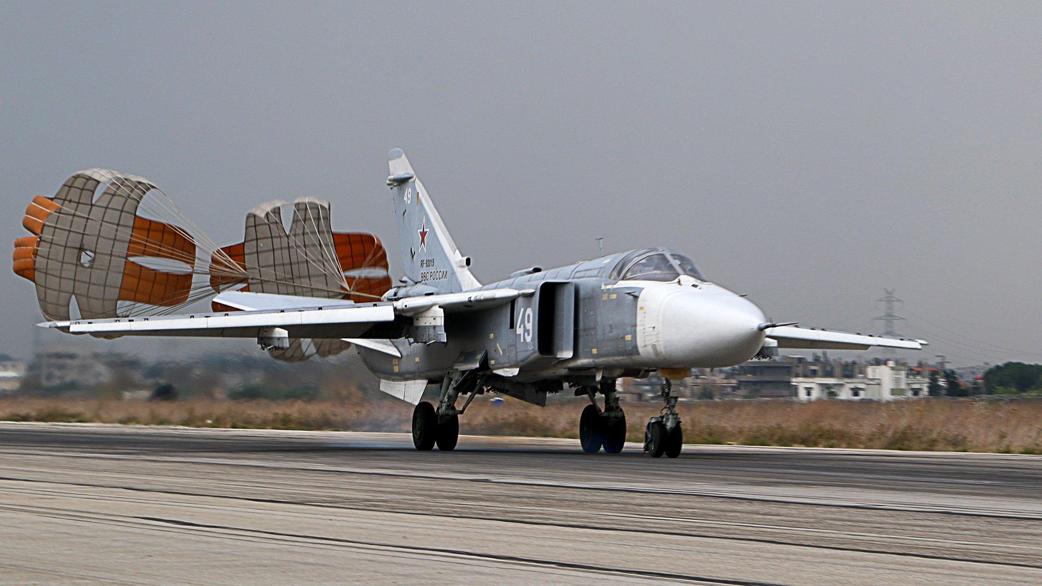 A Russian Sukhoi Su-24 bomber lands at the Russian Hmeimin military base in Latakia province, in the north-west of Syria (16 December 2015)