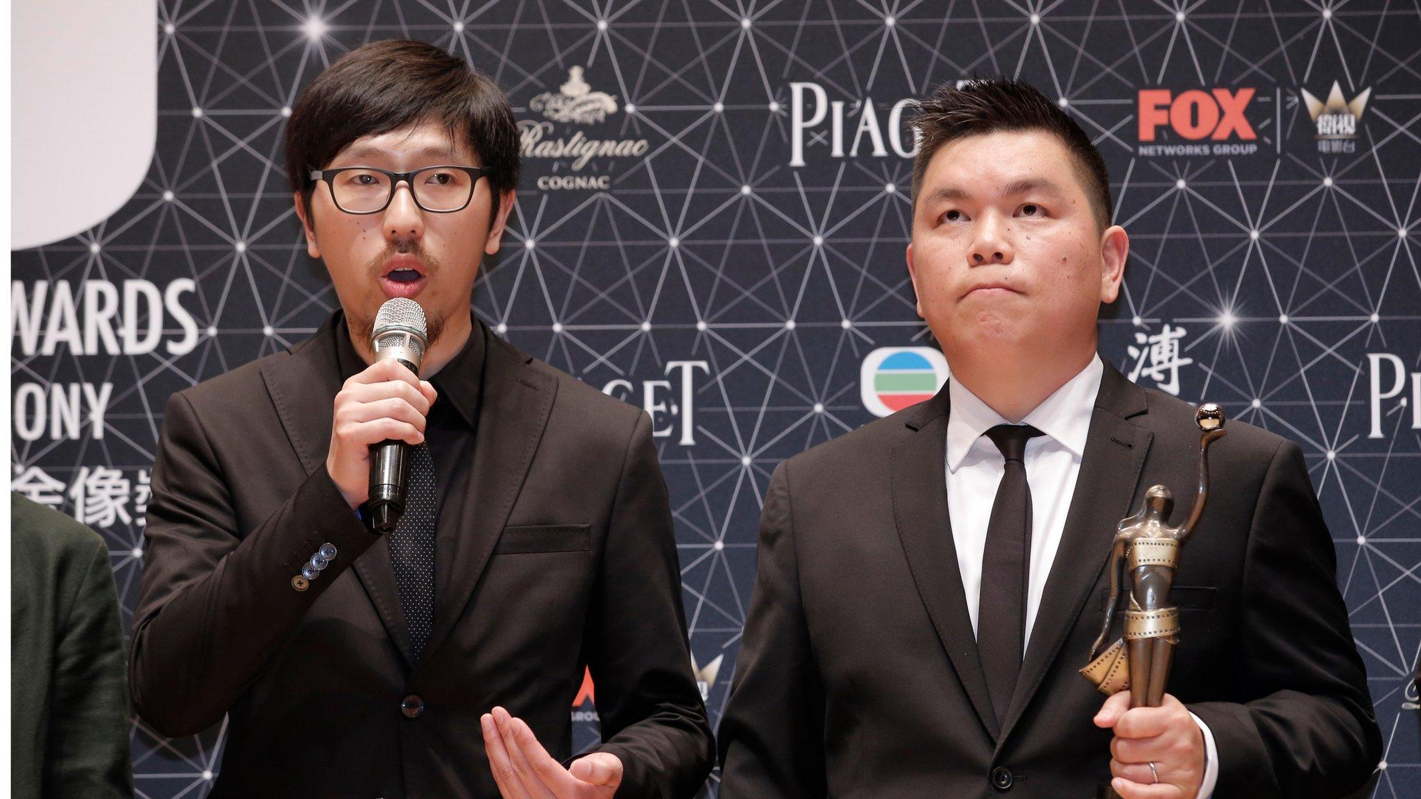 Hong Kong movie producer Andrew Choi, right, and director Ng Ka-leung pose after winning the Best Film award