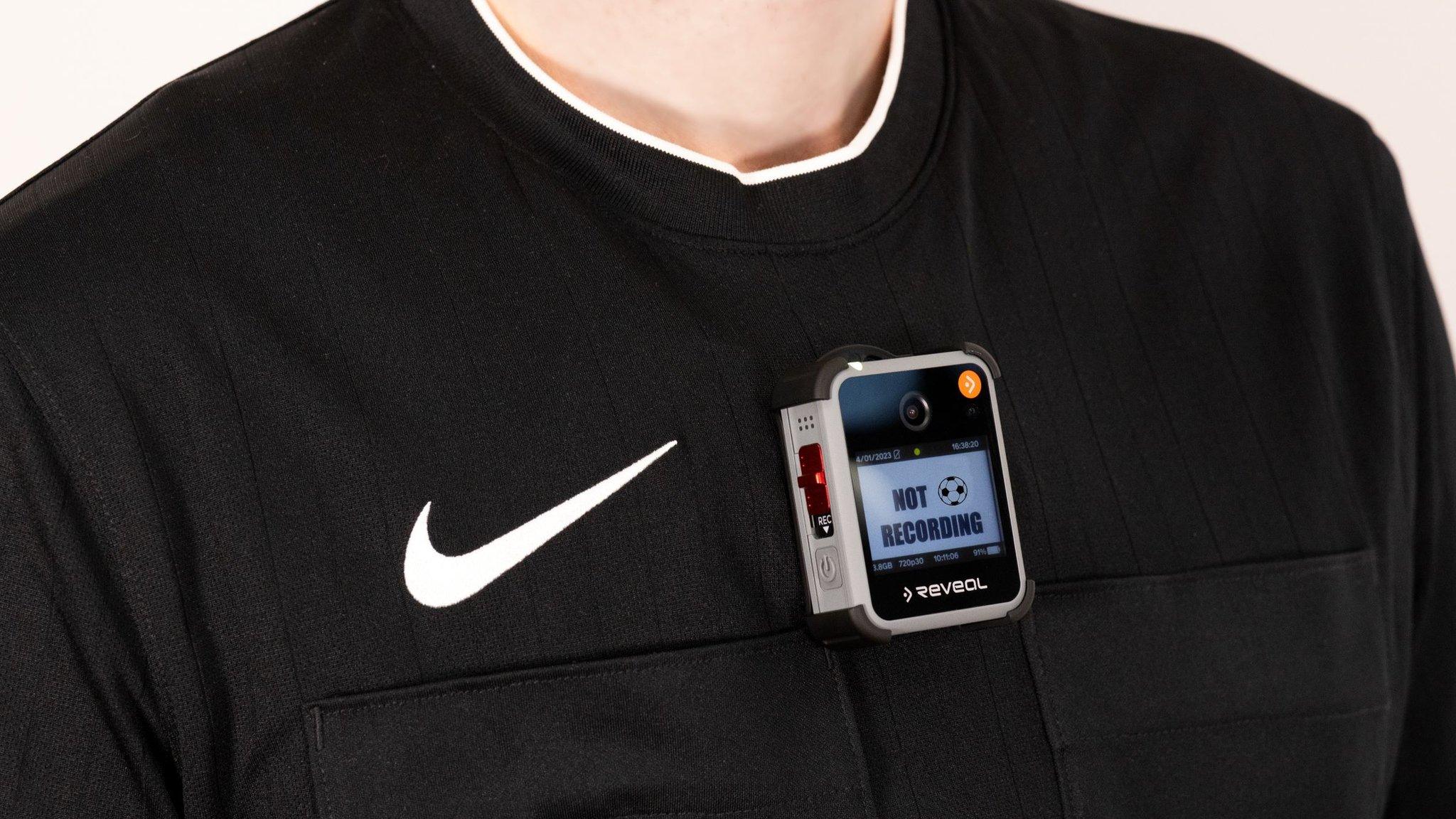 A referee wearing a bodycam on their chest